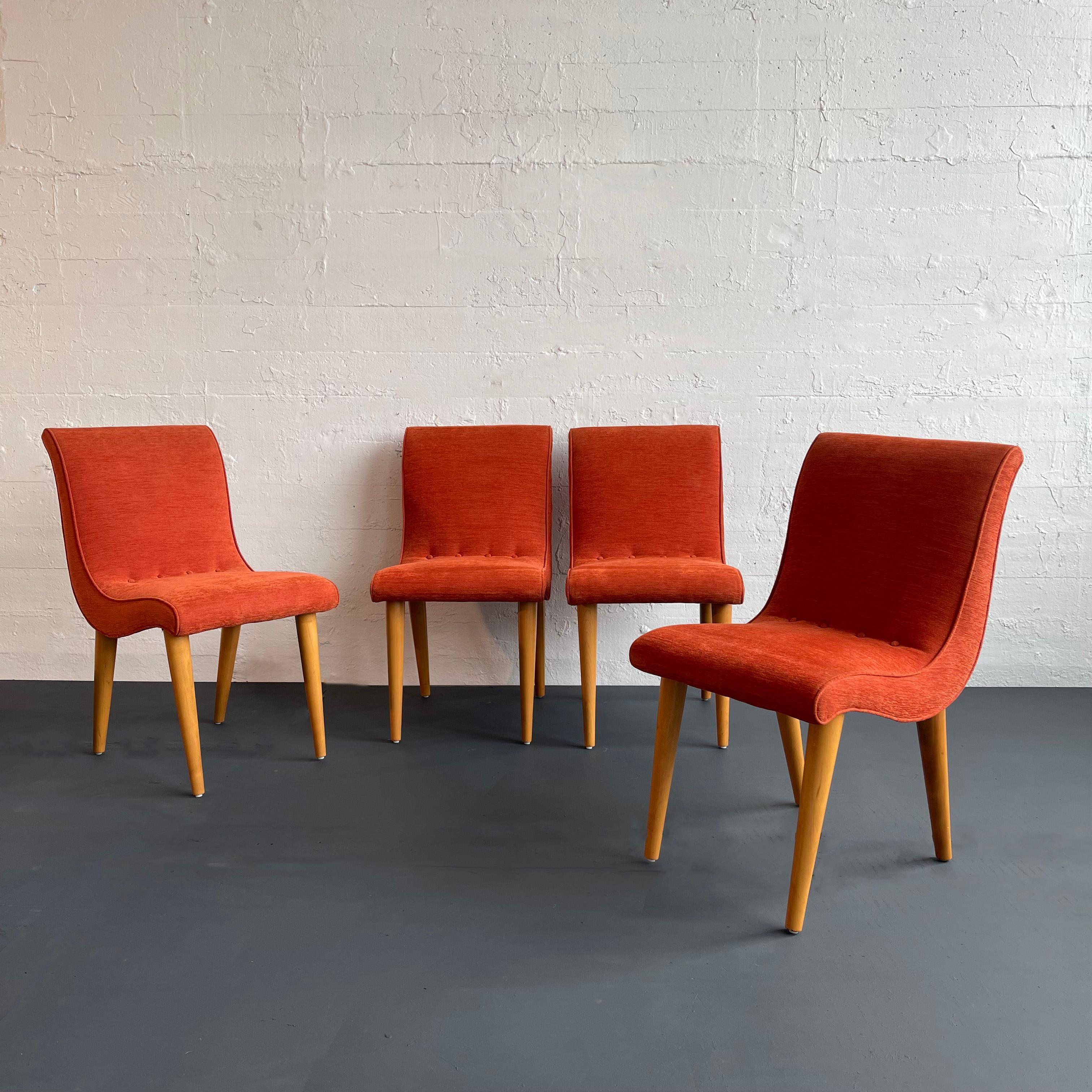 Stunning set of four, mid-century, art decco, upholstered dining chairs designed by the esteemed American designer Russel Wright for Conant Ball, circa 1940 feature a curvilinear, stylized s-form, scoop body with button-back detailing that rests on