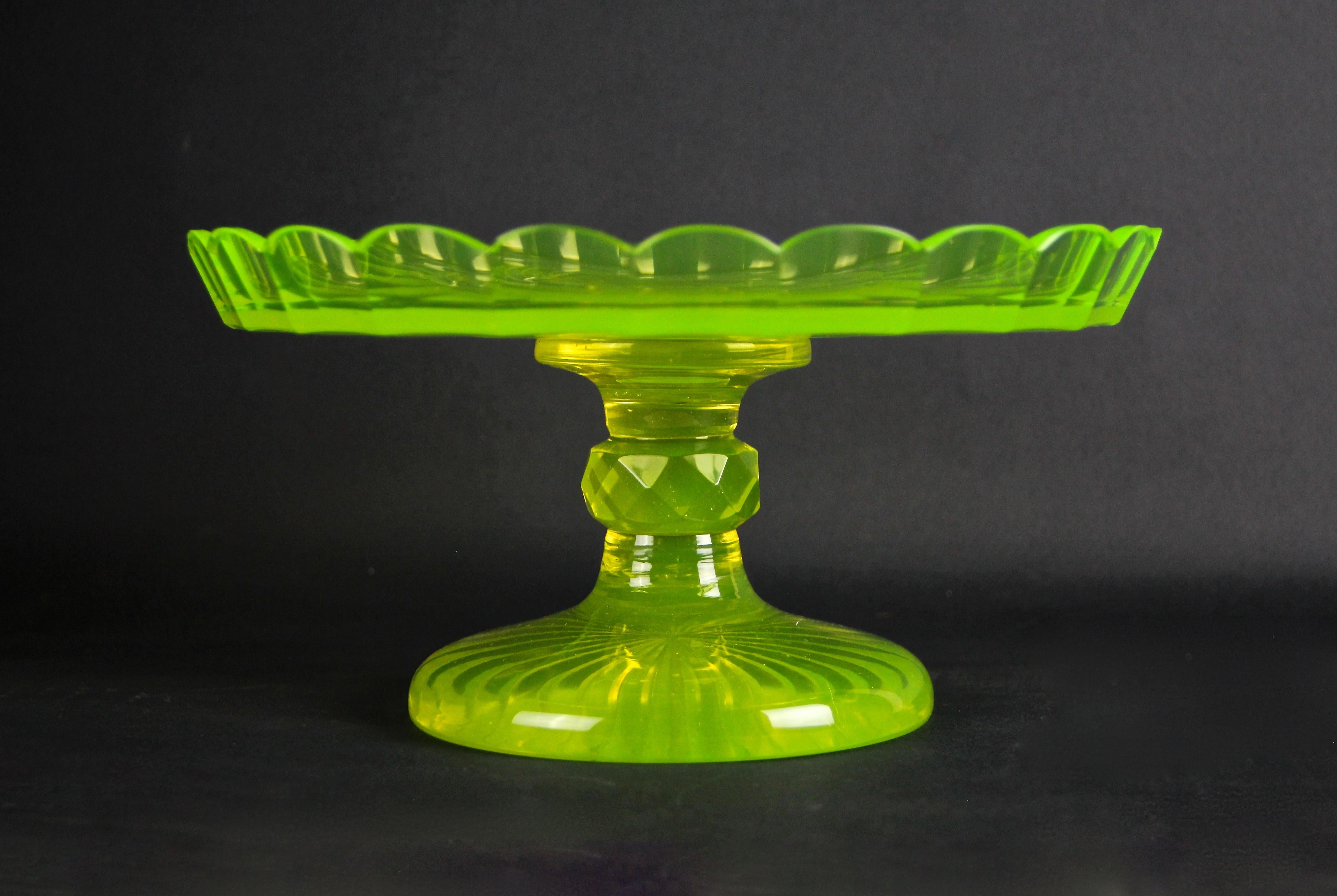 Delicate Art Deco uranium glass centerpiece from Austria, circa 1920. Colored in the typical light green tone, this very decorative glass centerpiece impresses with its lovely design. The artfully made glass bowl sits on a beautiful shaped base