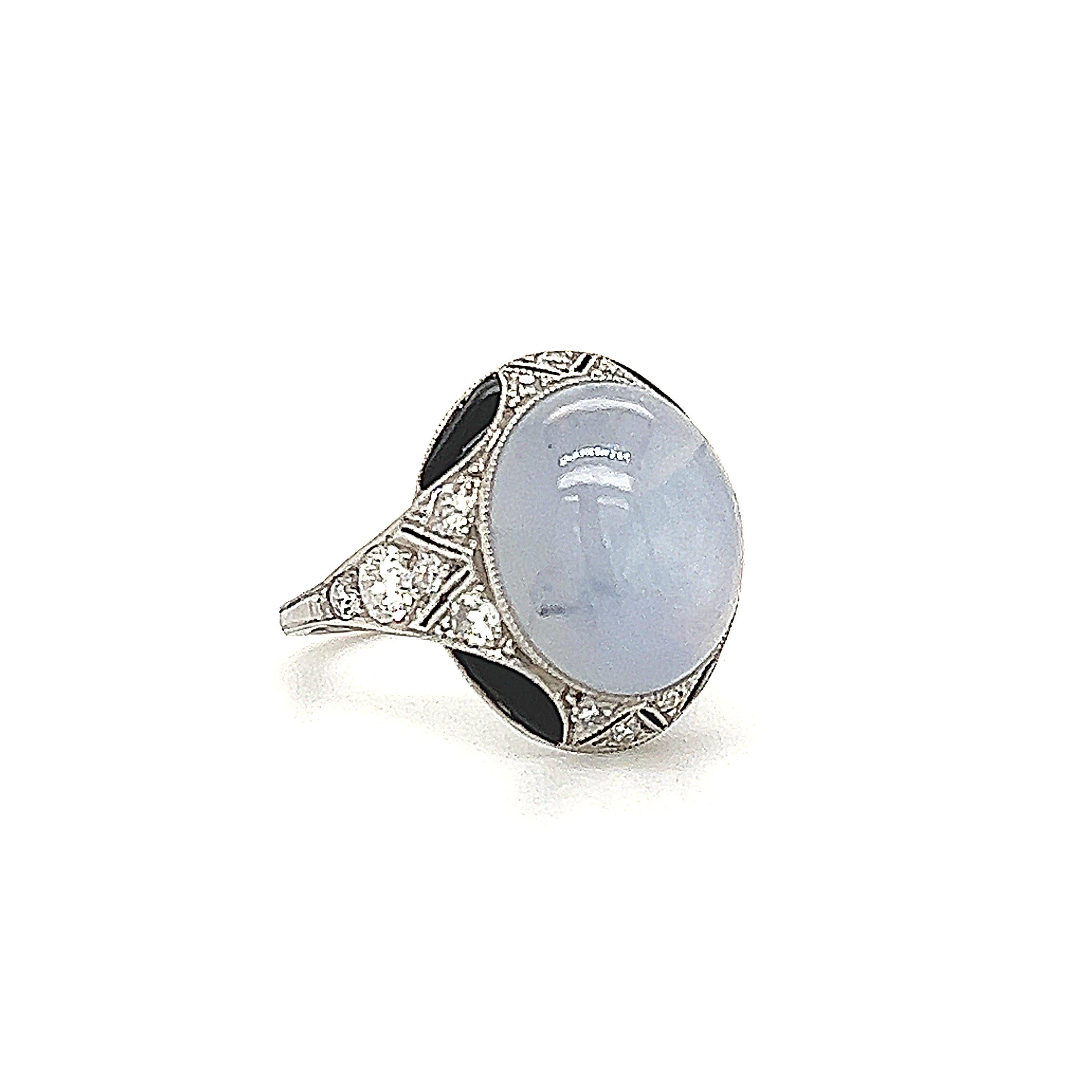 A breathtaking design from Van Cleef & Arpels. This stunning art deco ring is crafted in platinum with details throughout. The highlight of the design is a cabochon cut star sapphire that shows a dreamy shade of blue. The star sapphire shows