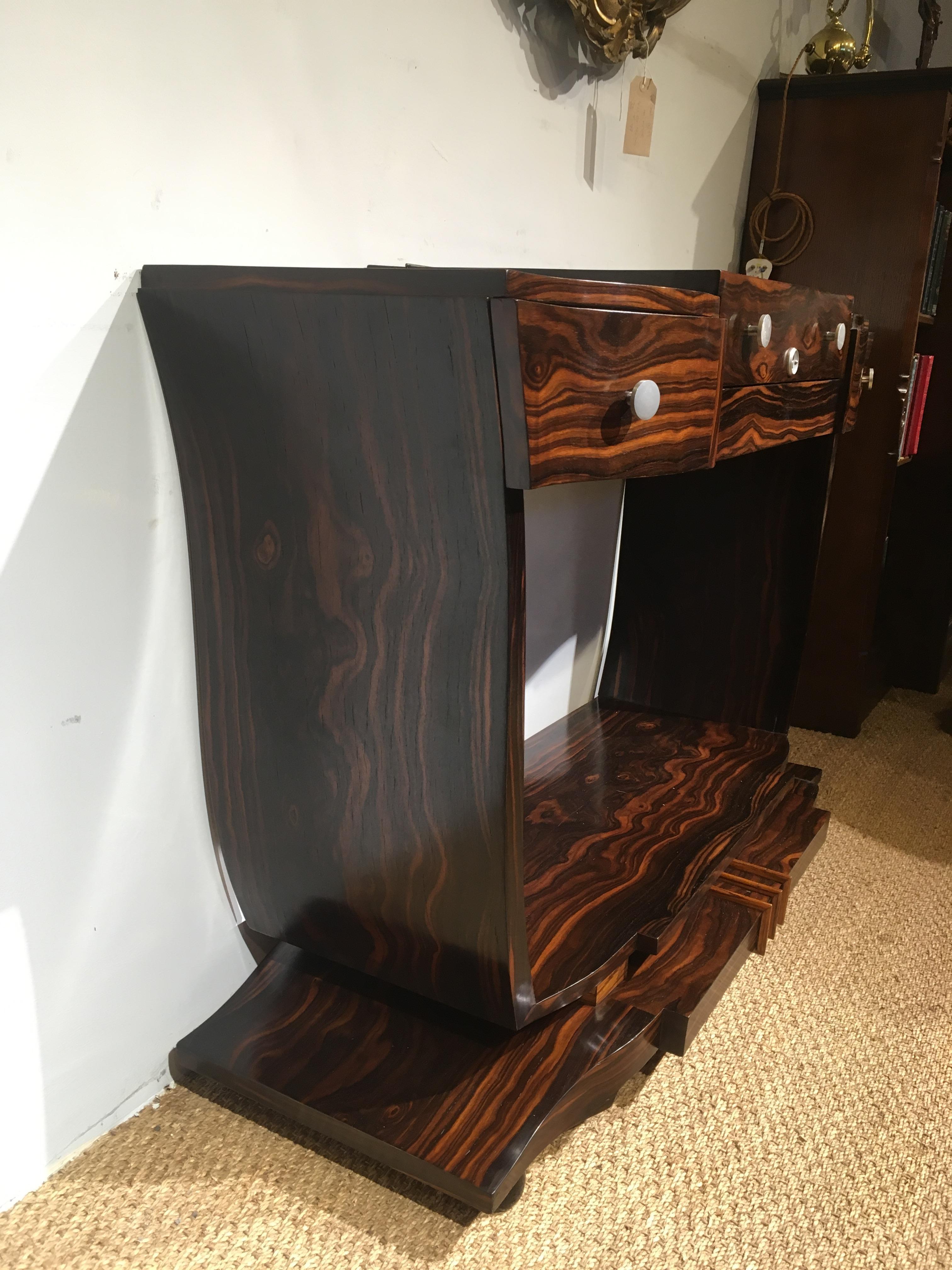Extremely stylish Art Deco period console table / dressing table

The whole piece veneered with figured Macassar ebony, having original chrome mounts.

This really is a statement piece, it has been through our workshops, cleaned and polished and