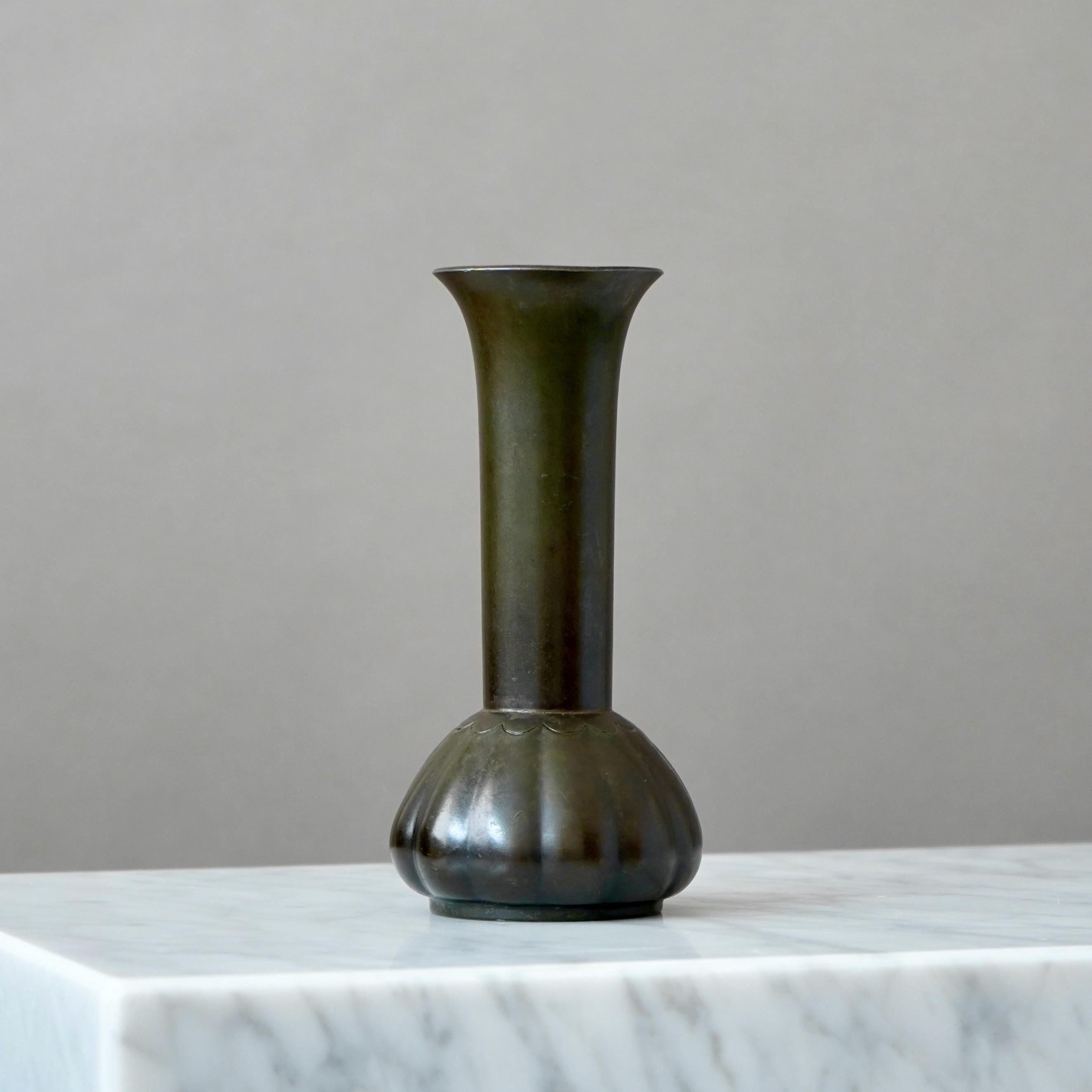 A beautiful art deco vase designed by Just Andersen in 1930s and produced by his own company in Denmark. Made from Disko metal (an alloy of different metals invented by Just Andersen).

Good condition. Some light scuffs and scratches.
Stamped with