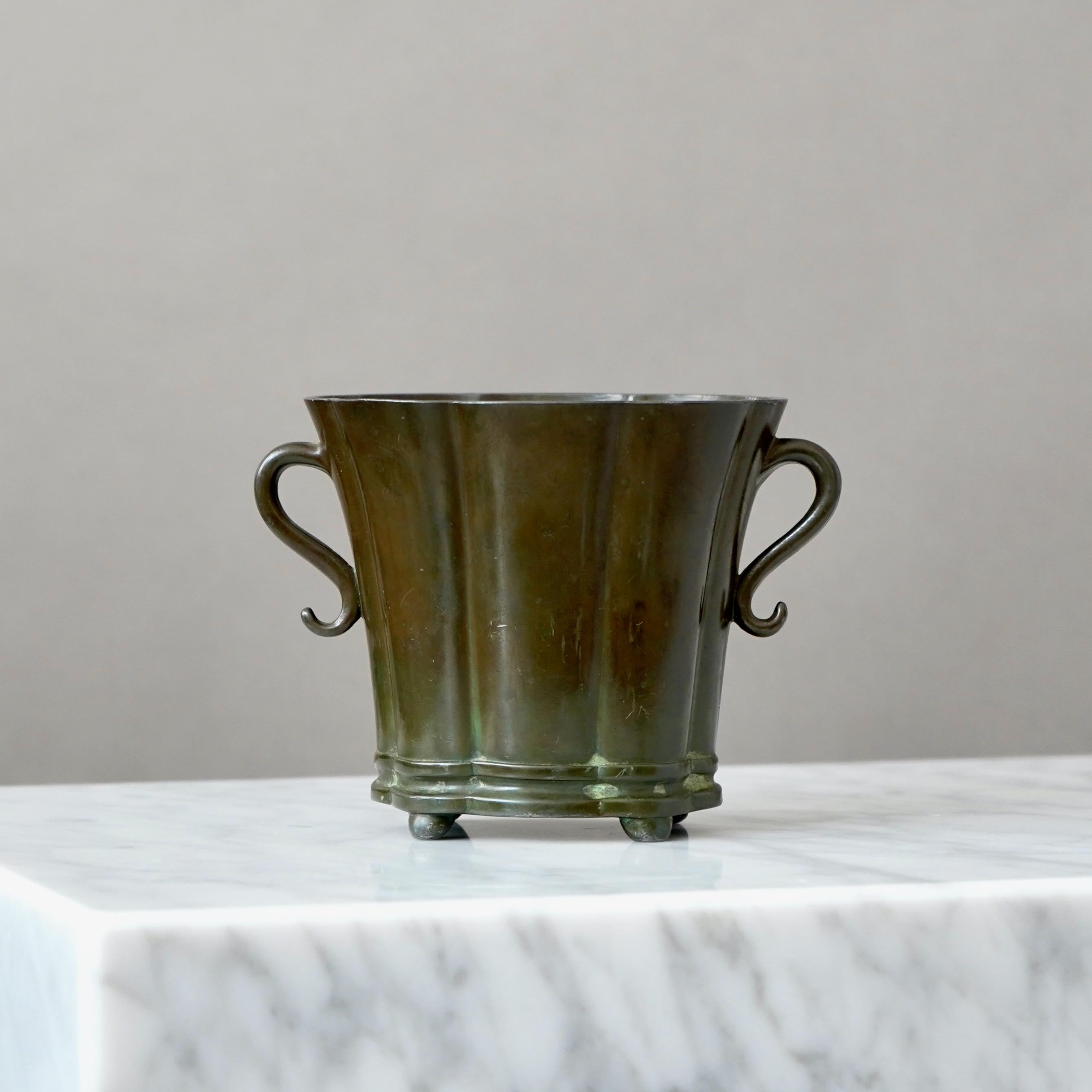 A beautiful art deco vase designed by Just Andersen in 1930s and produced by his own company in Denmark. Made from Disko metal (an alloy of different metals invented by Just Andersen).

Good condition. But with some scuffs and scratches.
Stamped