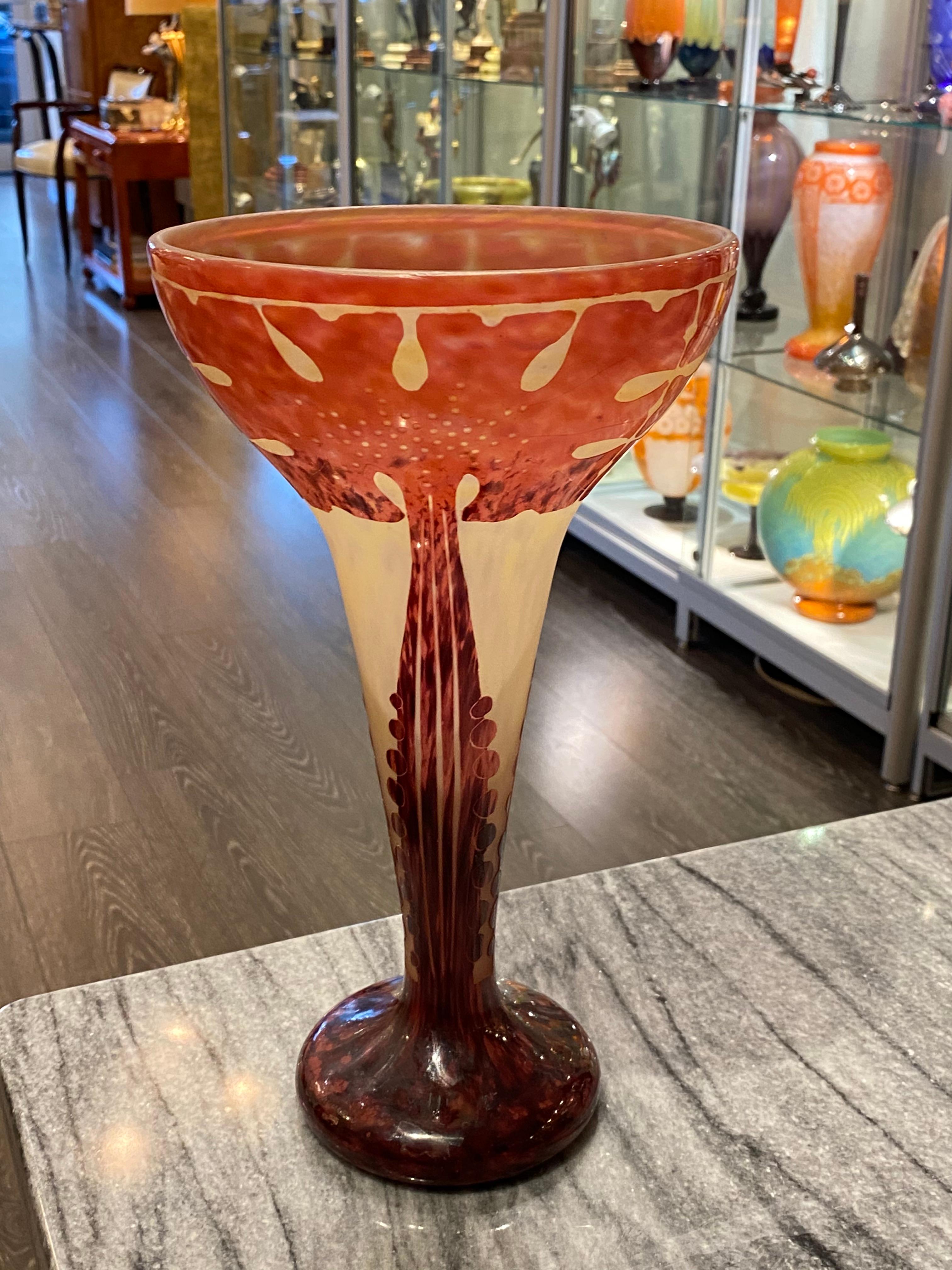 A coupe-shaped in Pale Yellow glass with Degradé of Violet.  The motif resembles the leaf of a monstera plant. The pattern is acid-etched. The stem and foot are in Violet.  This piece belongs to the 