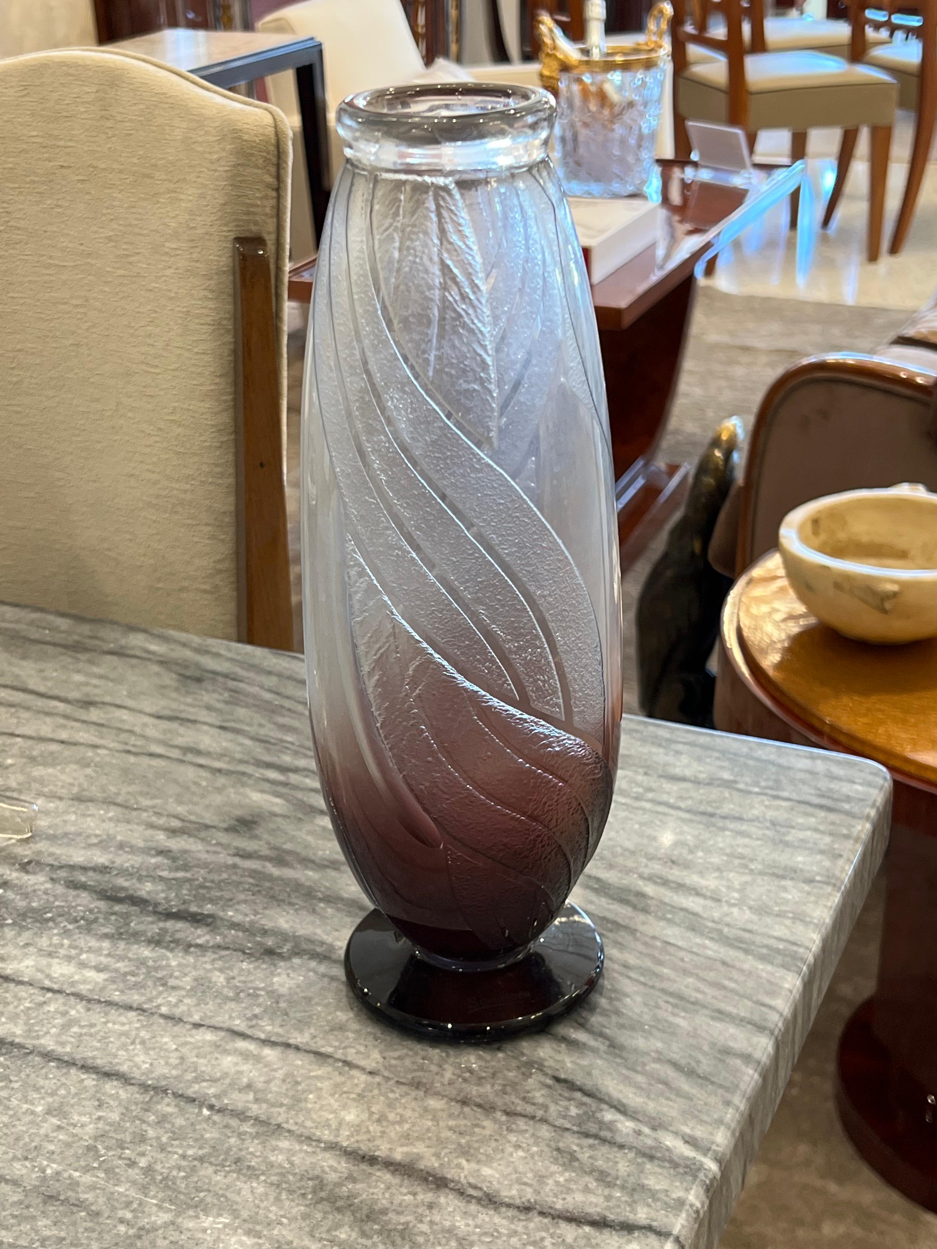 A cylindrical shaped glass vase in Clear glass with a degradé in Magenta designed by Le Verre Français.  This piece has an acid-etched twist pattern and a Magenta foot.

Charles Schneider was a renowned glassmaker during the Art Deco period in