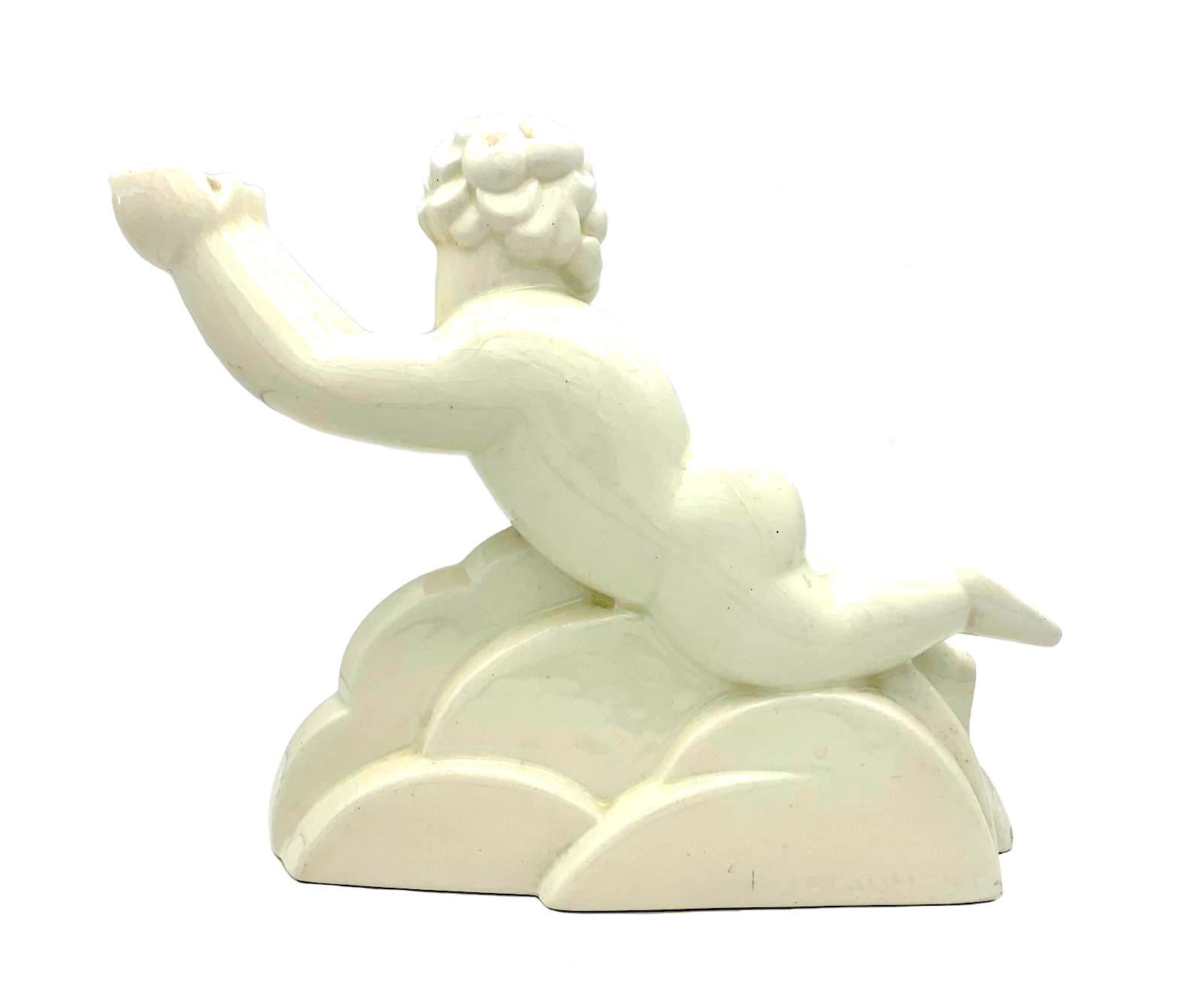 This lovely French Art Deco cherub was made at the beginning of the nineteen twenties. The ceramic vase was cast from a charming mould and has a beautiful cream coloured glaze weith crasquele. It is designed as a chubby cherub supported by a pile of