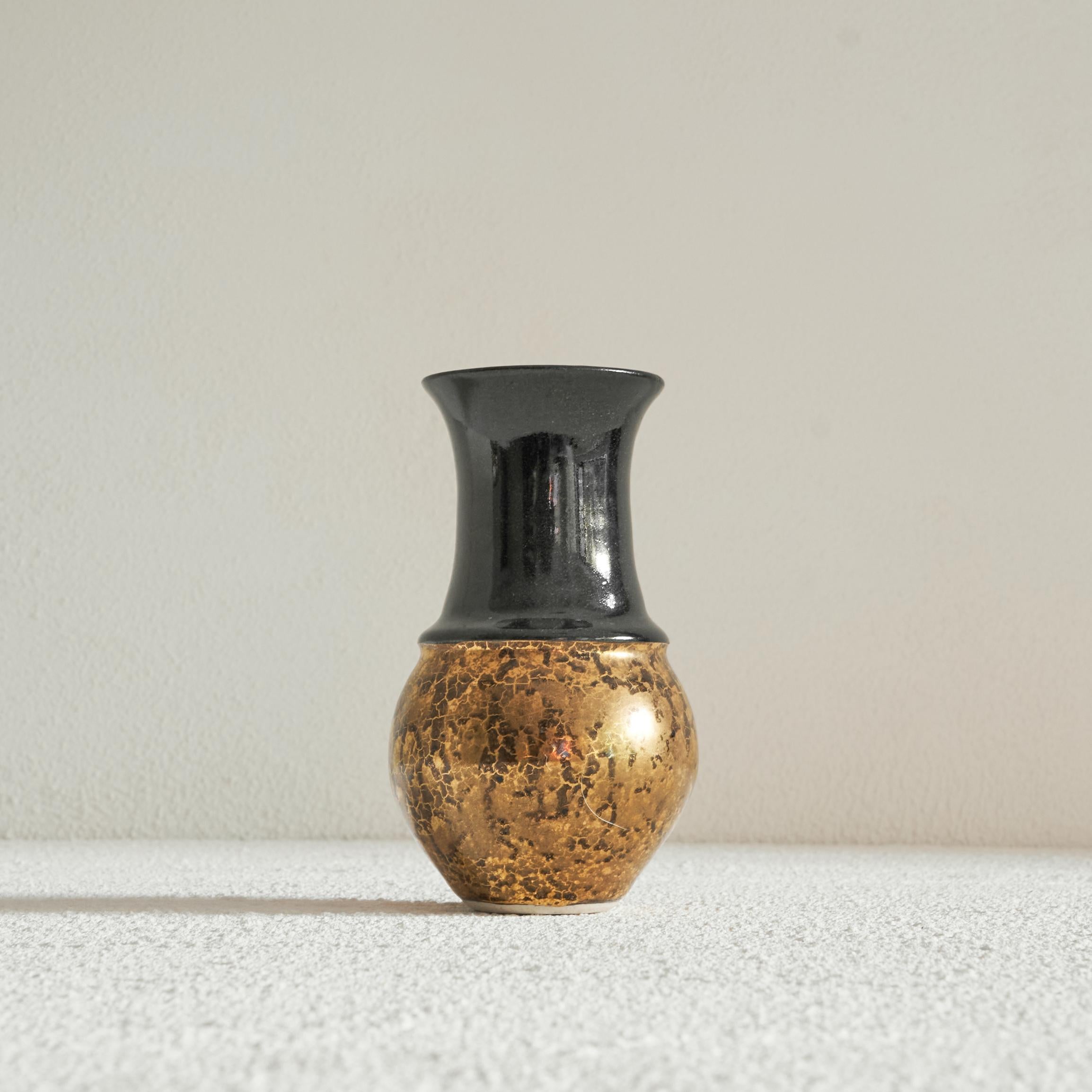 Art Deco vase in Black and Gold Craquelé, early 20th century.

Stylish and distinct art deco vase in gold craquelé and black. Elegant shape, with a nice contrast between the gold and the black. 

Signed FvH, probably stands for the name of the