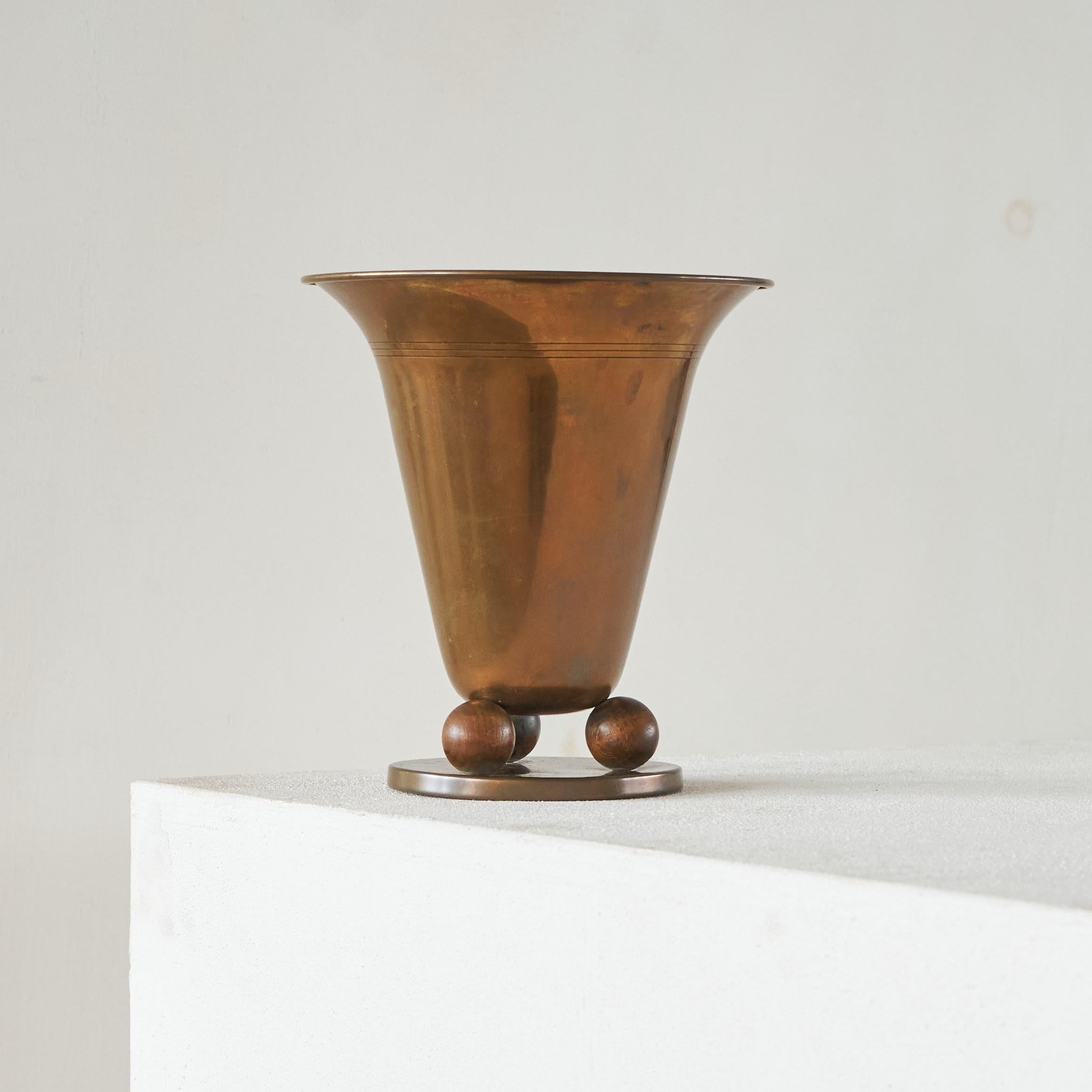 Art Deco Vase in Copper and Wood, Europe, 1930s.

This is a wonderful fluted vase in patinated copper and wood. Very art deco, a wonderful piece on your table or desk. Great as a decorative item on its own, but also beautiful with some flowers or