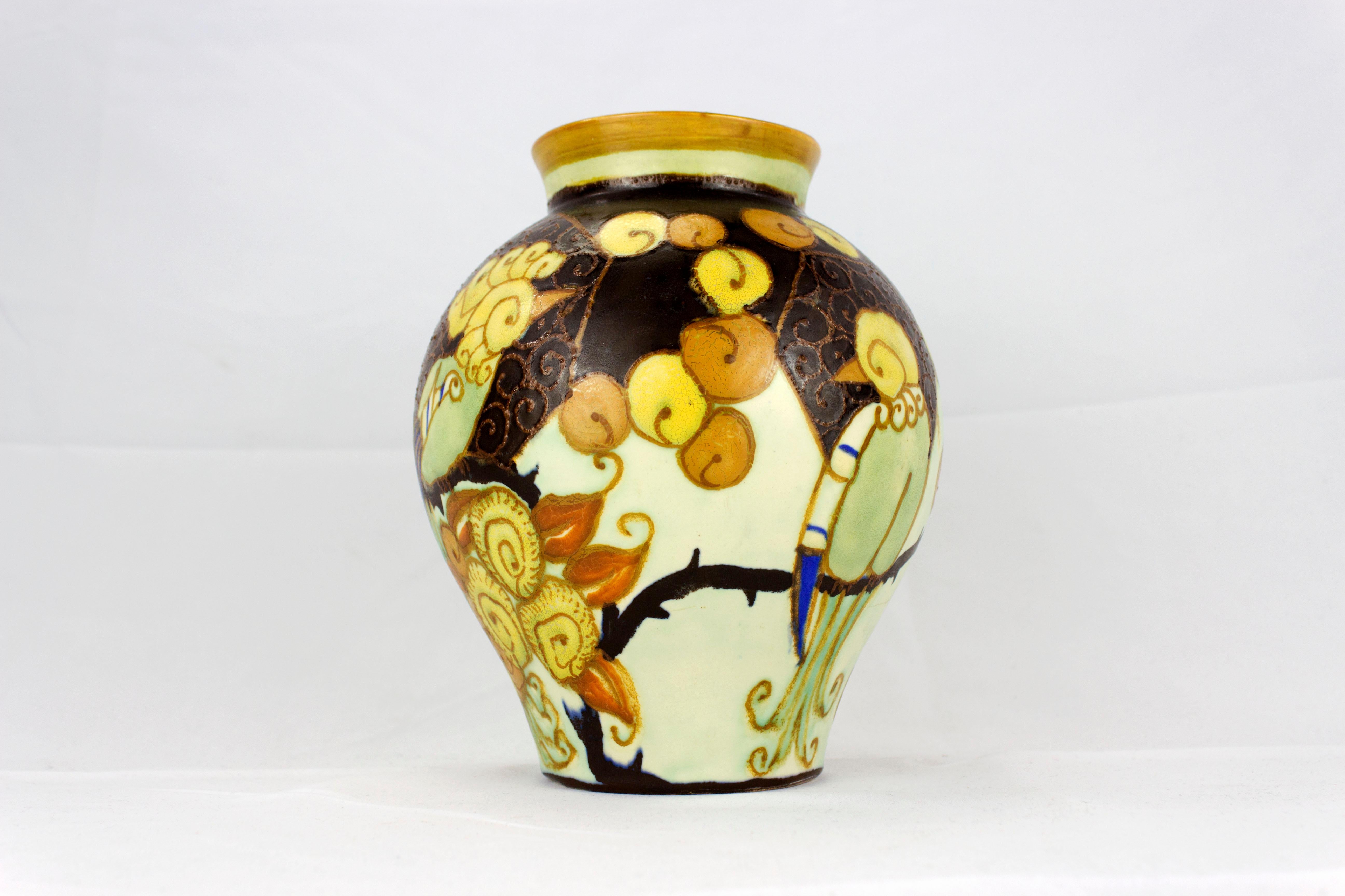 he Art Deco vase by Keramis, created in 1927, is an exquisite masterpiece of Belgian ceramics that bears the signature of Charles Catteau, a prominent contributing artist to the Keramis collection. This vase is adorned with a meticulous polychrome