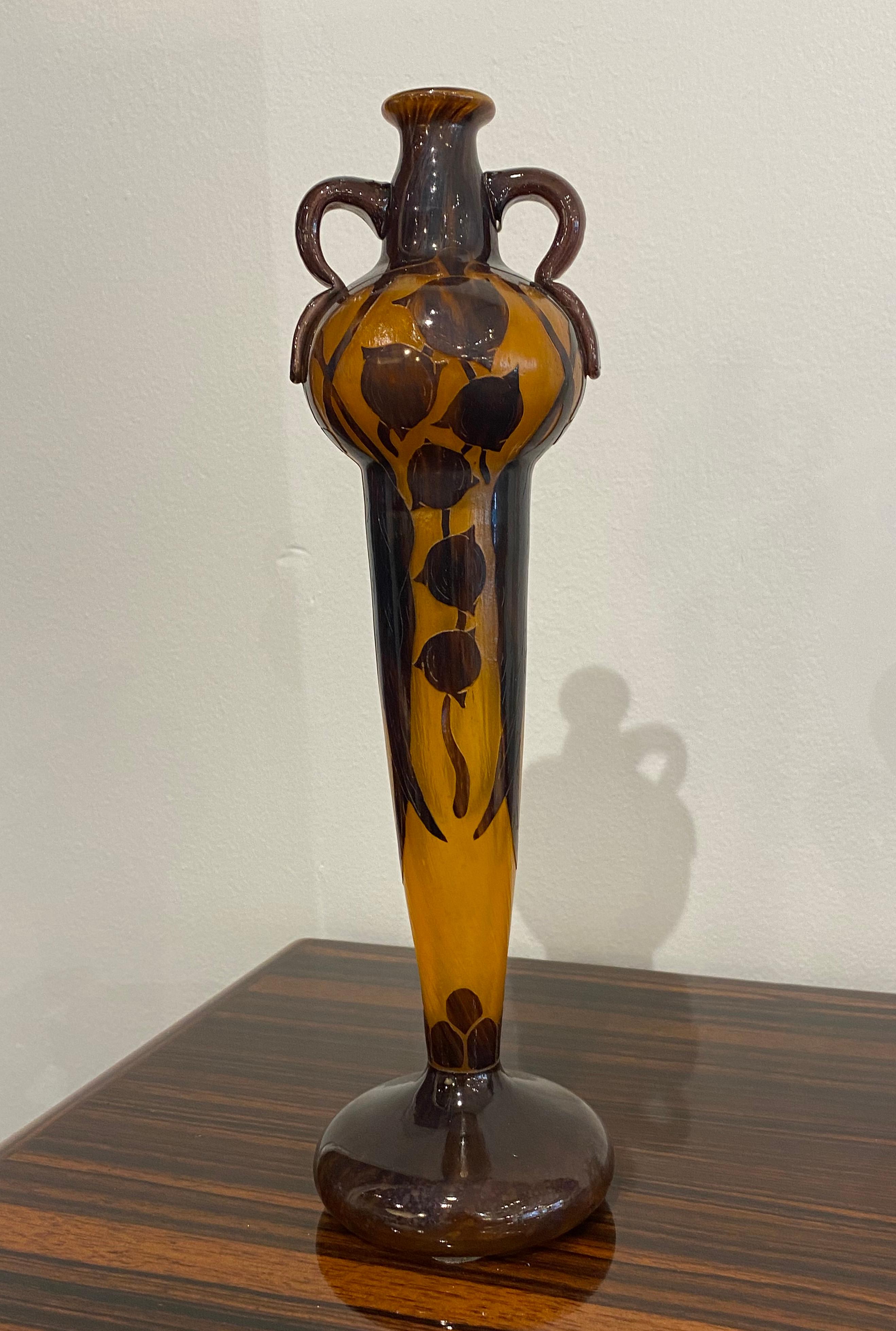 Art Deco glass vase in the cameo technique by Le Verre Francais depicting the Eucalyptus pattern, in orange and brown.
Made in France
Circa: 1919
Signature: candy cane in the vase.