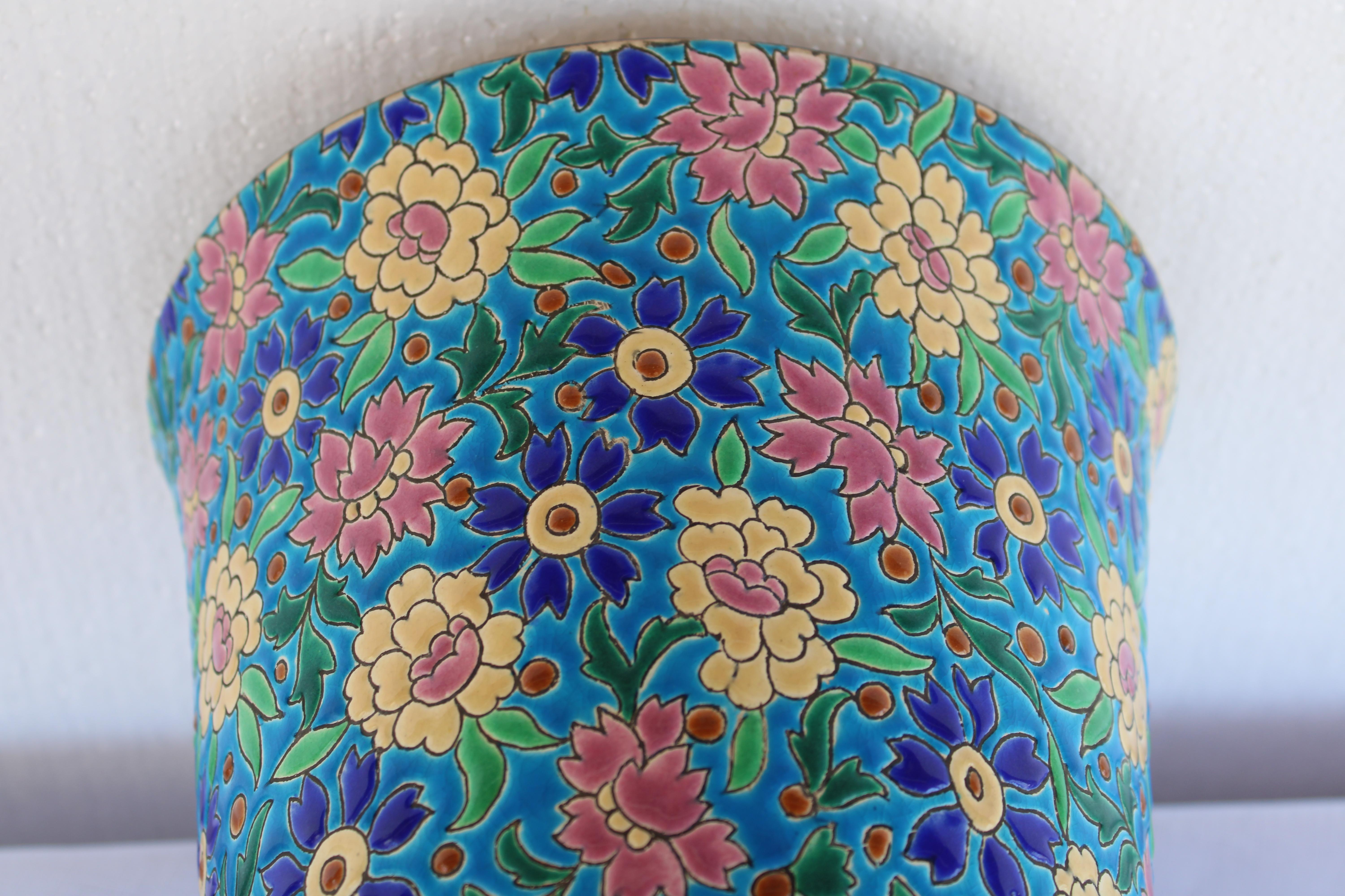 Glazed Art Deco vase manufactured by Emaux de Longwy, France.  Covered with bold flowers in full bloom this Art Deco vase was made by the famed Longwy ceramic company in France.  Longwy was established towards the end of the 17th century in a