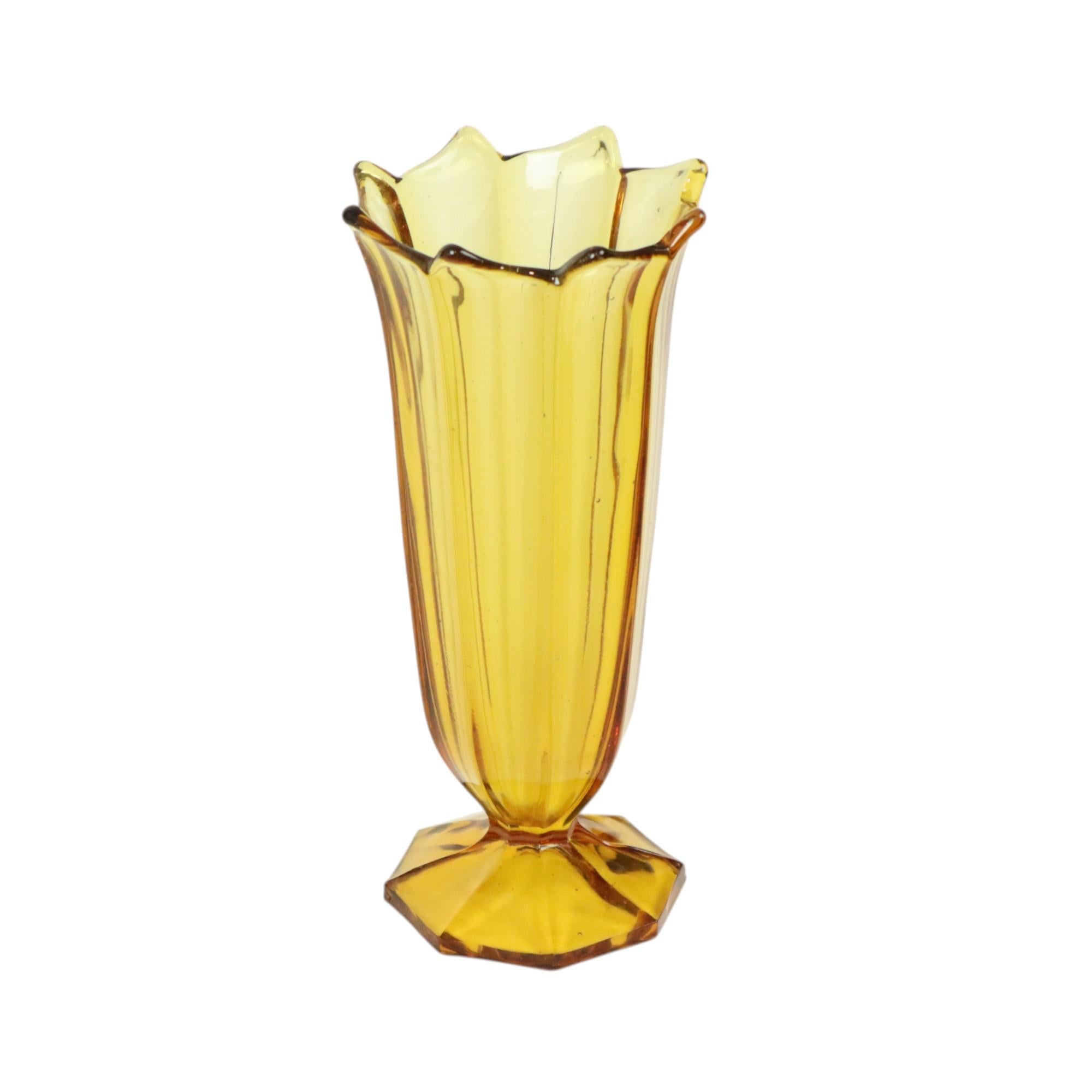 A beautiful Art Deco vase made of amber-colored pressed glass, better known as Depression glass, probably by Rosice Glassworks, Czech Republic. It is unmarked but entirely in the Bohemian style of the maker.

This object contains glass threads, air