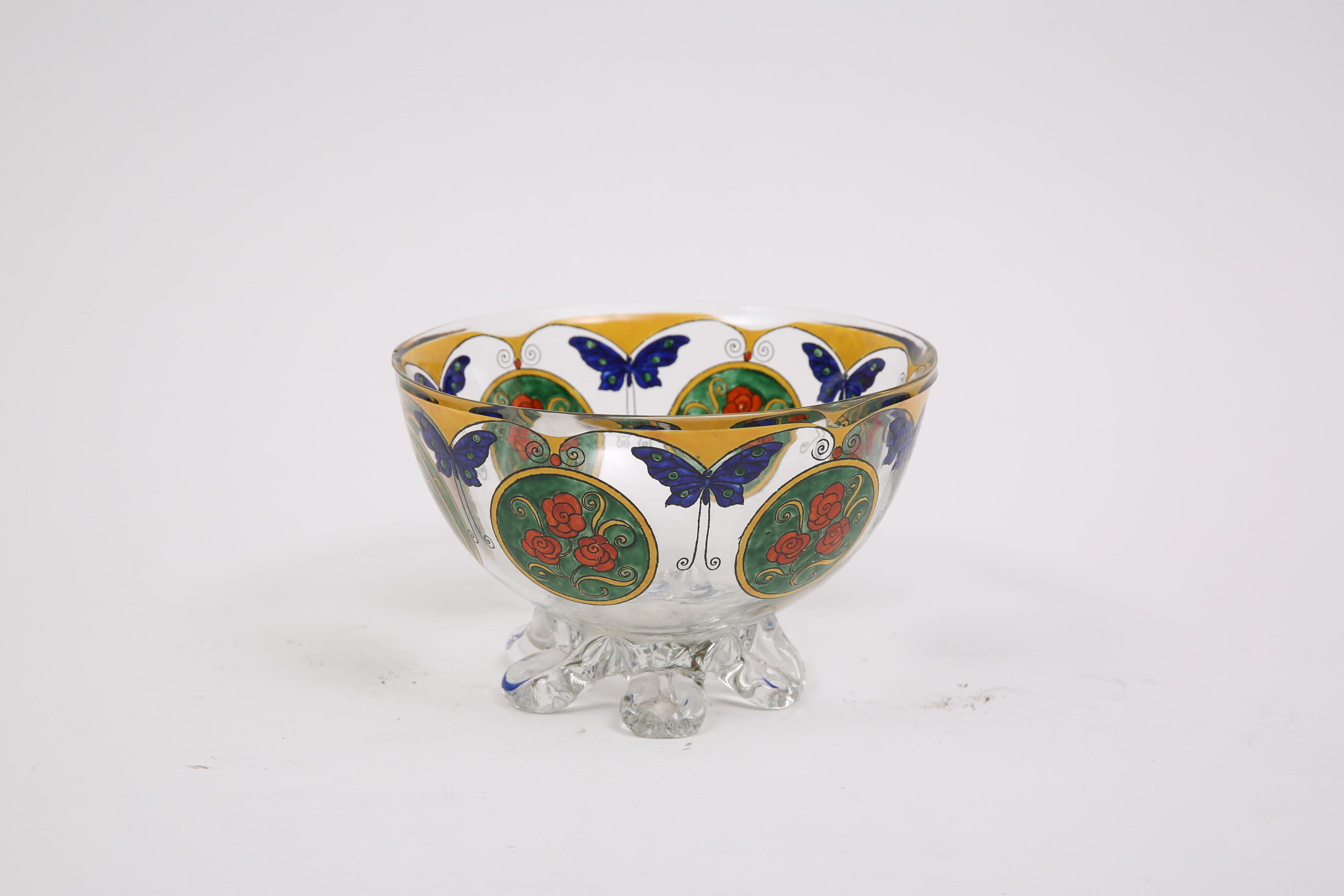 Charming goblet on glass feet decorated with butterflies and roses by the crystal factory of Sevres, from the 1925 period. Very stylized art-deco piece with enamel decoration, beautiful bright colors on this rotating decor alternating with