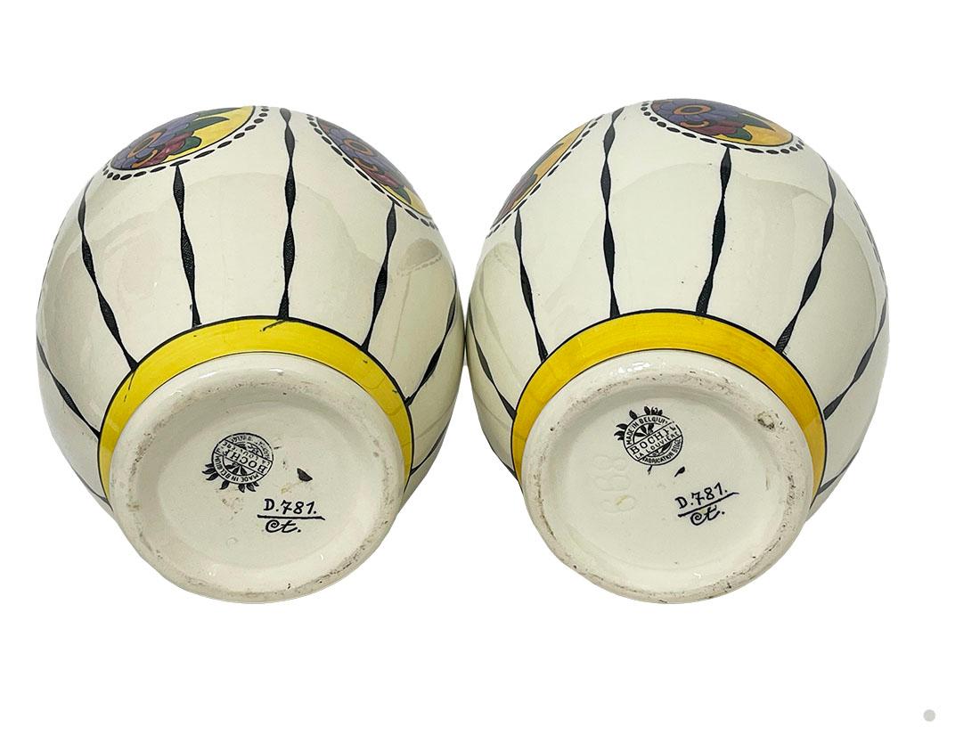 Art Deco vases by Charles Catteau for Boch Frères, D781, 1920s

Two oval vases, Art Deco of 27 cm high The vases are decorated with thin black lines interspersed with medallions adorned with flowers and leaves. The neck and foot are finished with a