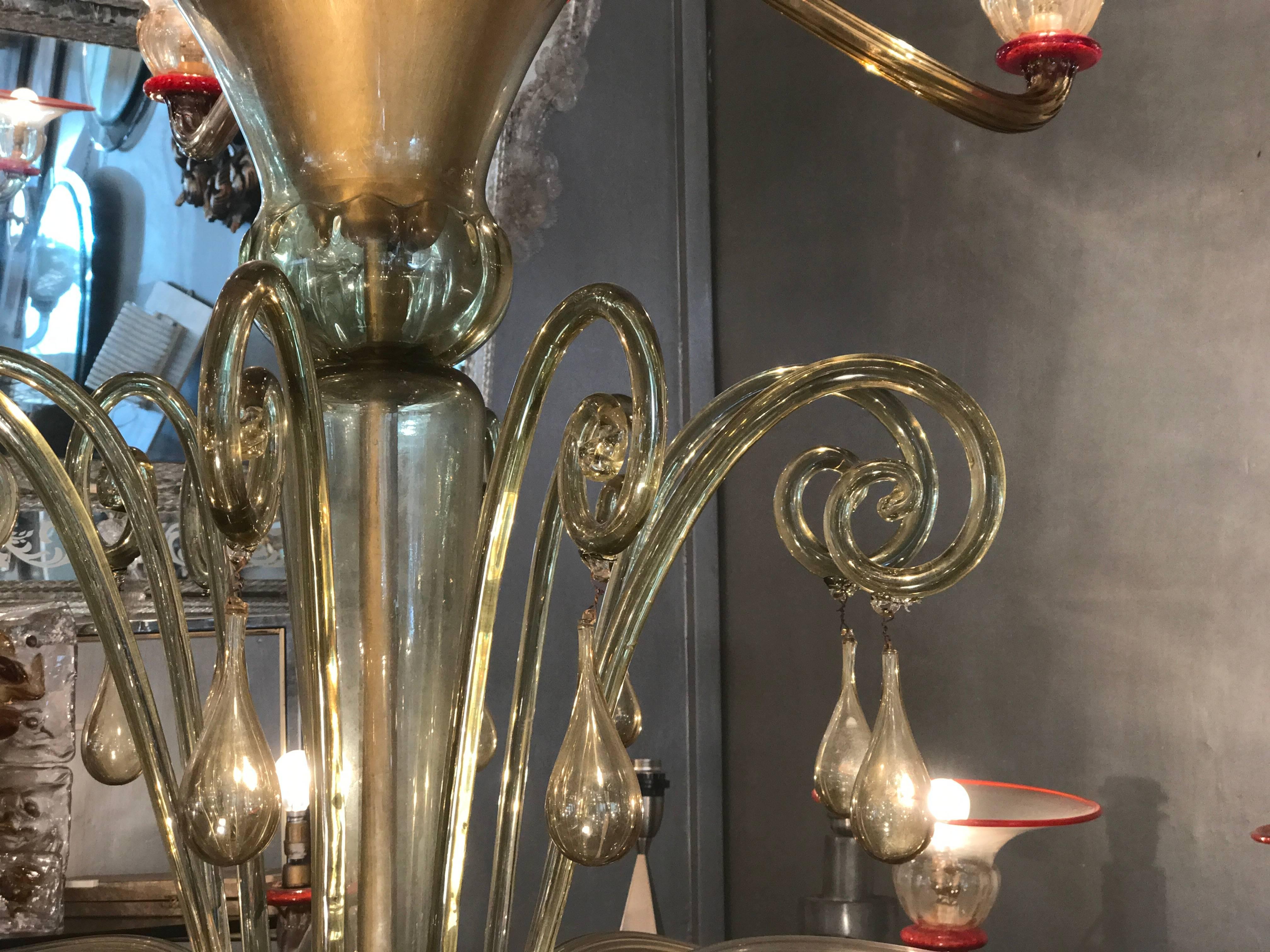 This outstanding amber and coral red hand blown Murano glass chandelier on three levels with 18 arms, designed by Napoleone Martinuzzi.
Piece of great value and elegance.
All glass parts are in excellent original condition with no cracks or