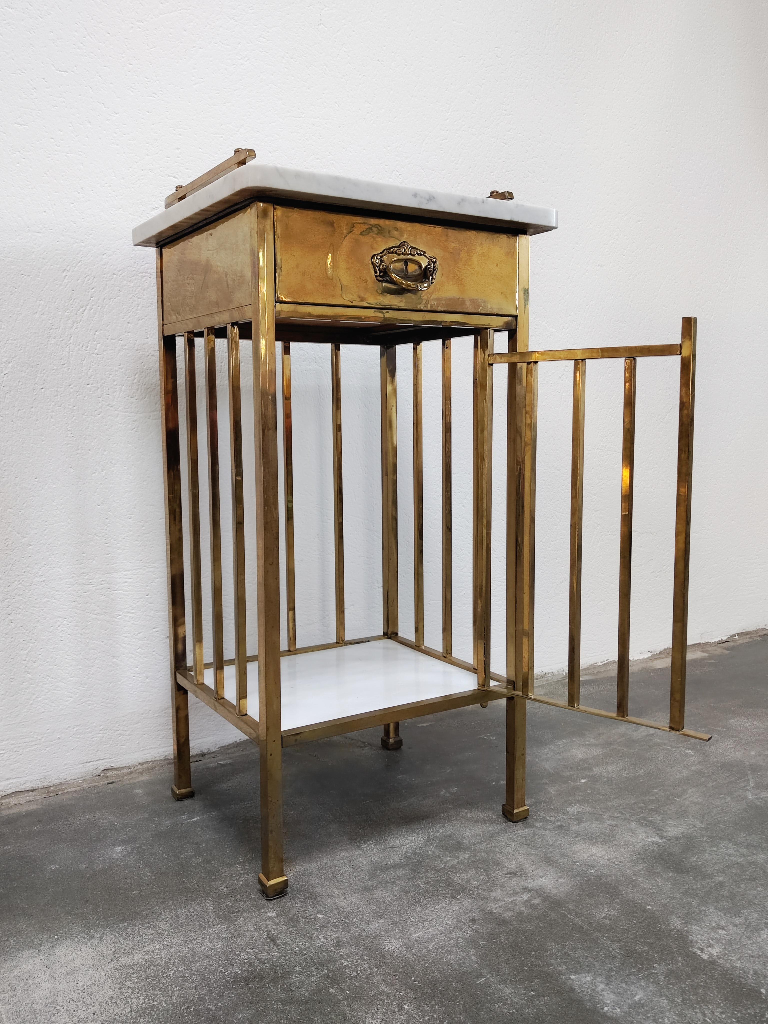 In this listing you will find an absolutely spectacular nightstand or bathroom cabinet done in solid brass and marble. This piece was made at dawn of the 20th century in Vienna, and it combines elements of Viennese Secession and Art Deco. This