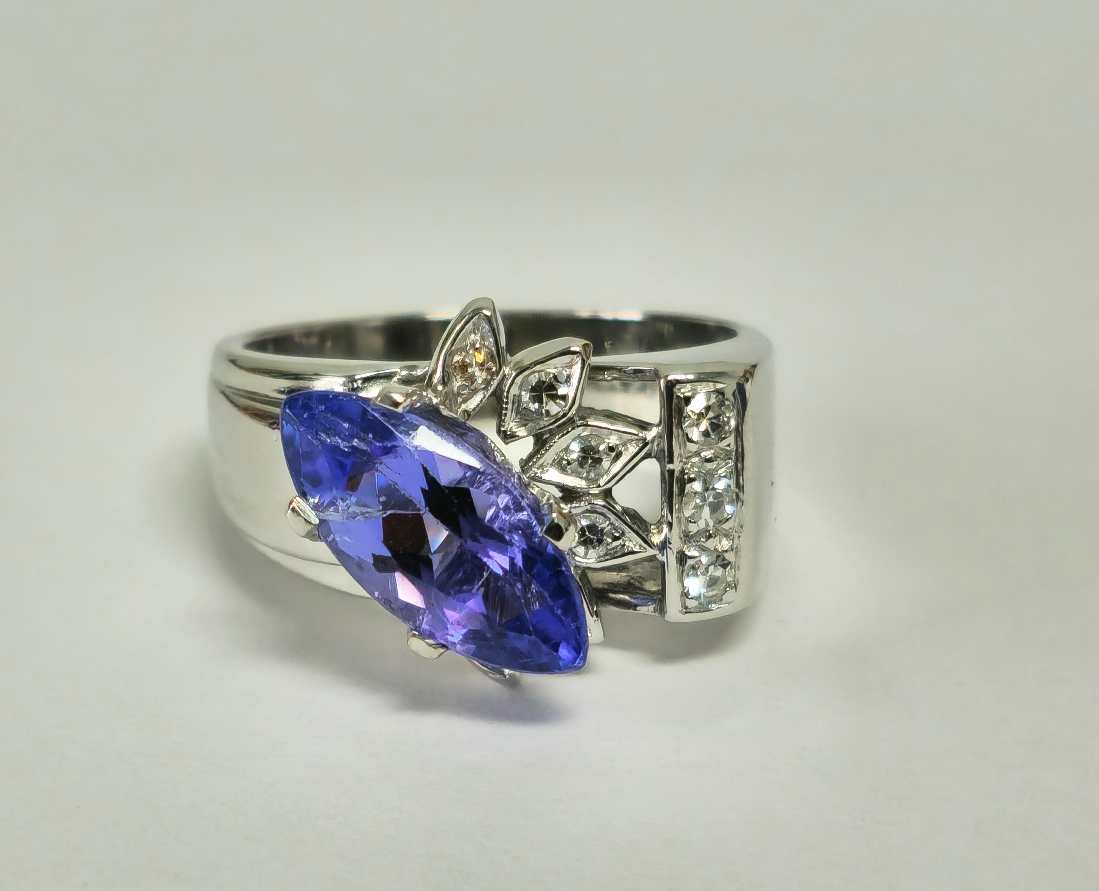 Introducing this exquisite vintage art deco cocktail ring for her, crafted from 14k white gold and adorned with a stunning 2.07 carat marquise-cut tanzanite, showcasing its natural earth-mined beauty. Accentuating the centerpiece are 0.18 carats of