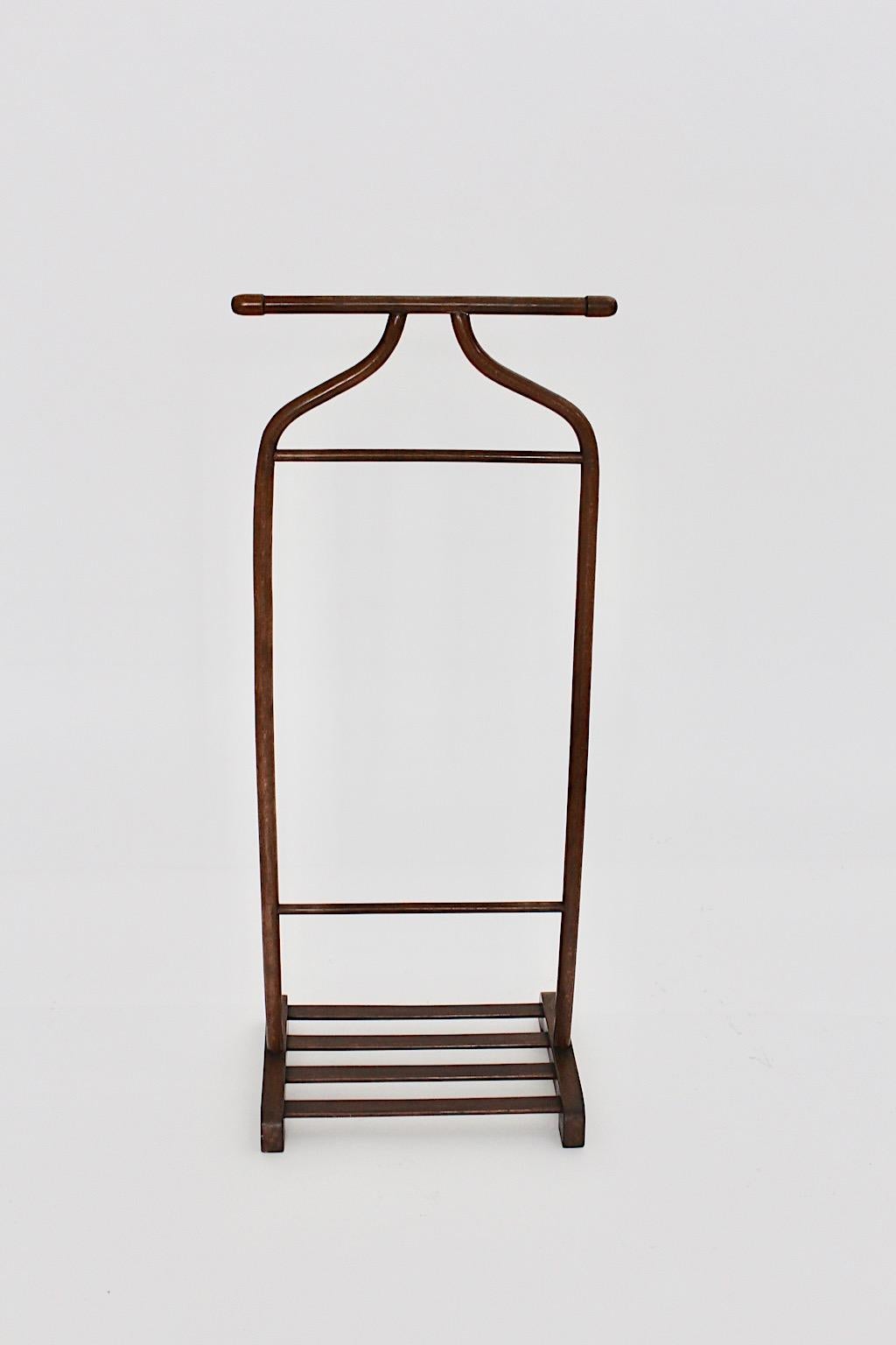 Art Deco vintage valet or coat rack from brown stained beech designed and made by Gebr. Thonet, Vienna, 1920s.
Throughout its warm wooden tone and its practical form the valet would be beautiful for anyone, who is looking for a classical addition