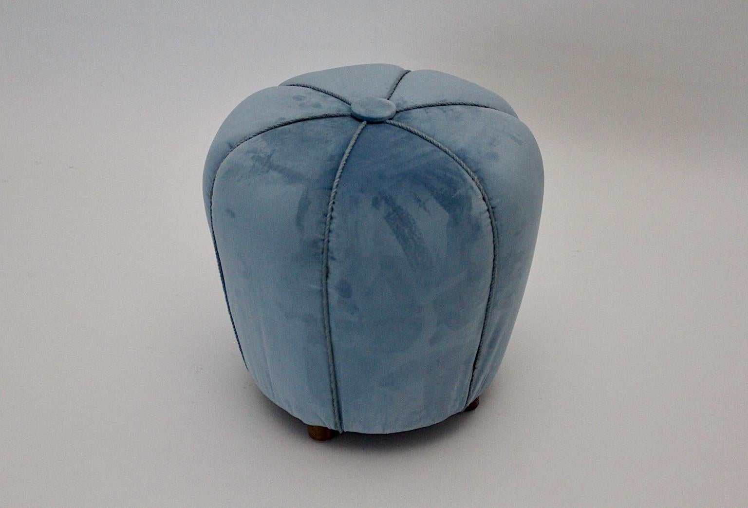 Art Deco vintage pouf stool ottoman with walnut feet reupholstered in blue velvet fabric and blue cords.
Through the stunning shape and the blue pastel color tone the pouf or stool could be a graceful point in your environment.
Very good