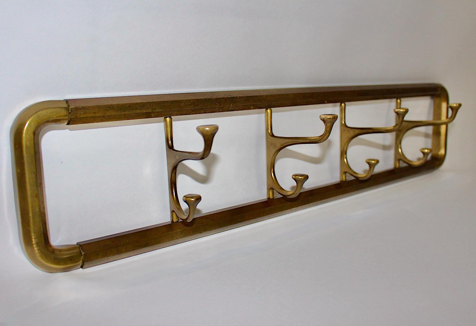Art Deco vintage wall mounted coat rack or coat hooks or towel rack from brass 1930s Austria.
An amazing wall mounted rack from brass with 4 swiveling hooks and 4 smaller sized hooks with beautiful patina.
This rectangular coat rack works