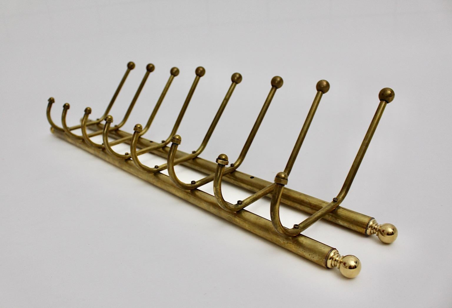 Art Deco vintage coat rack or rack with coat hooks from solid brass 1930s Austria.
A wonderful coat rack or coat hooks from solid brass with eight hooks for your coats and hats.
The rack is easy to mount with five screws at the wall.
The