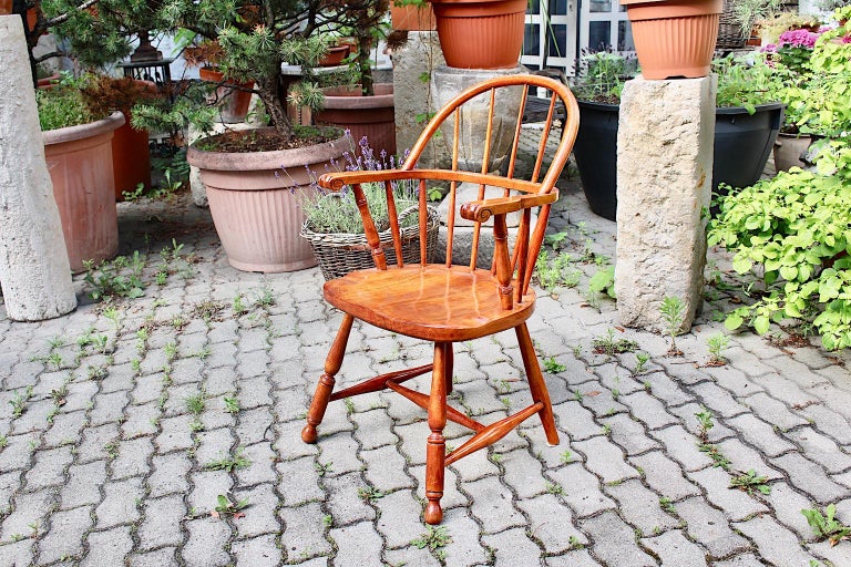 Art Deco vintage brown beech armchair or Windsor chair, which was designed by Josef Frank, circa 1925, Austria.
The armchair was made from solid beech, cherry stained and natural lacquered. So the warm brown tone could fit great with eclectic mixing