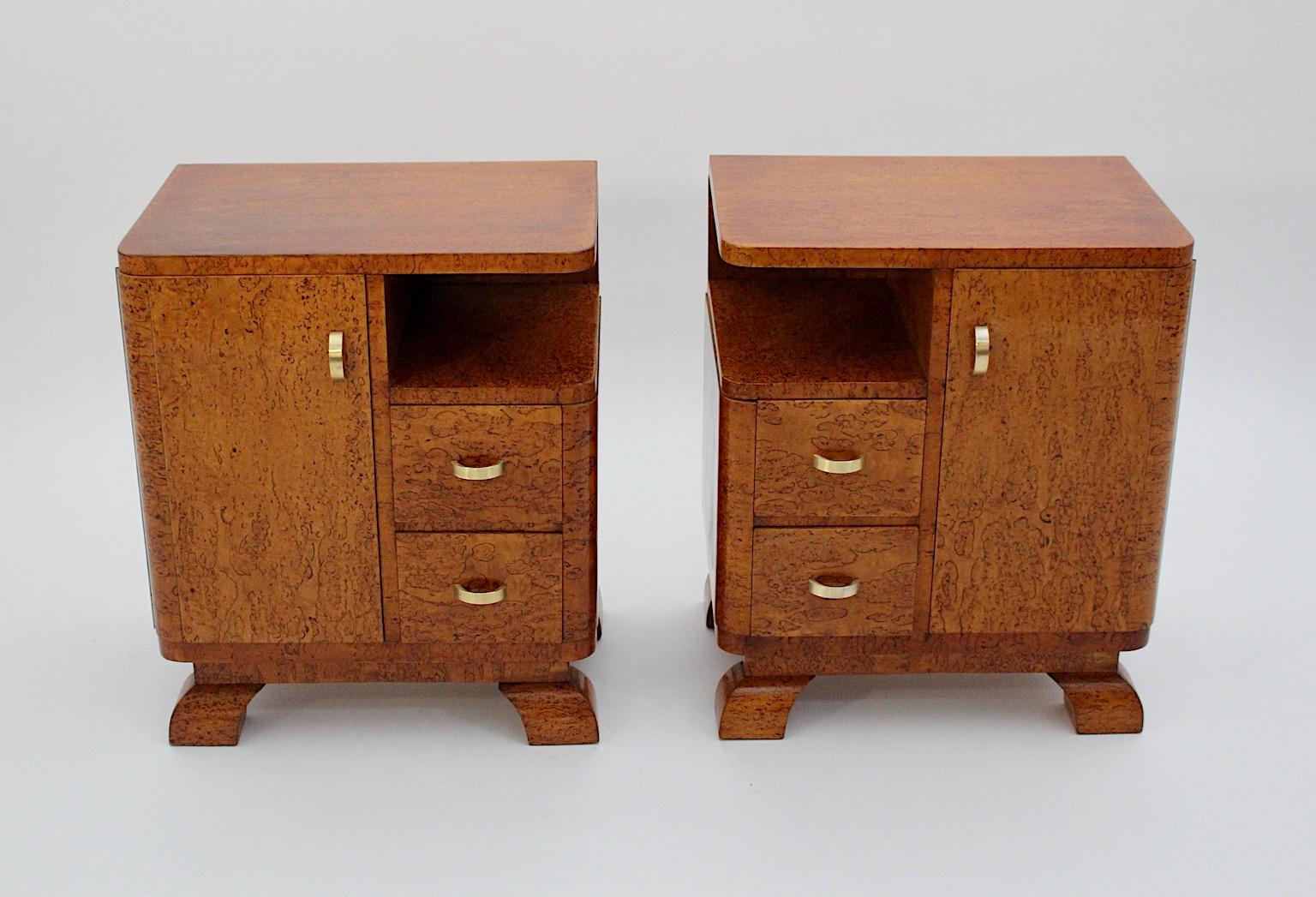 Art Deco vintage pair duo nightstands bedside tables from soft brown poplar veneer and brass 1930s Austria.
An amazing pair of nightstands or bedside tables from poplar veneer with brass handles, each nightstand shows 2 drawers and 1 door.
While the