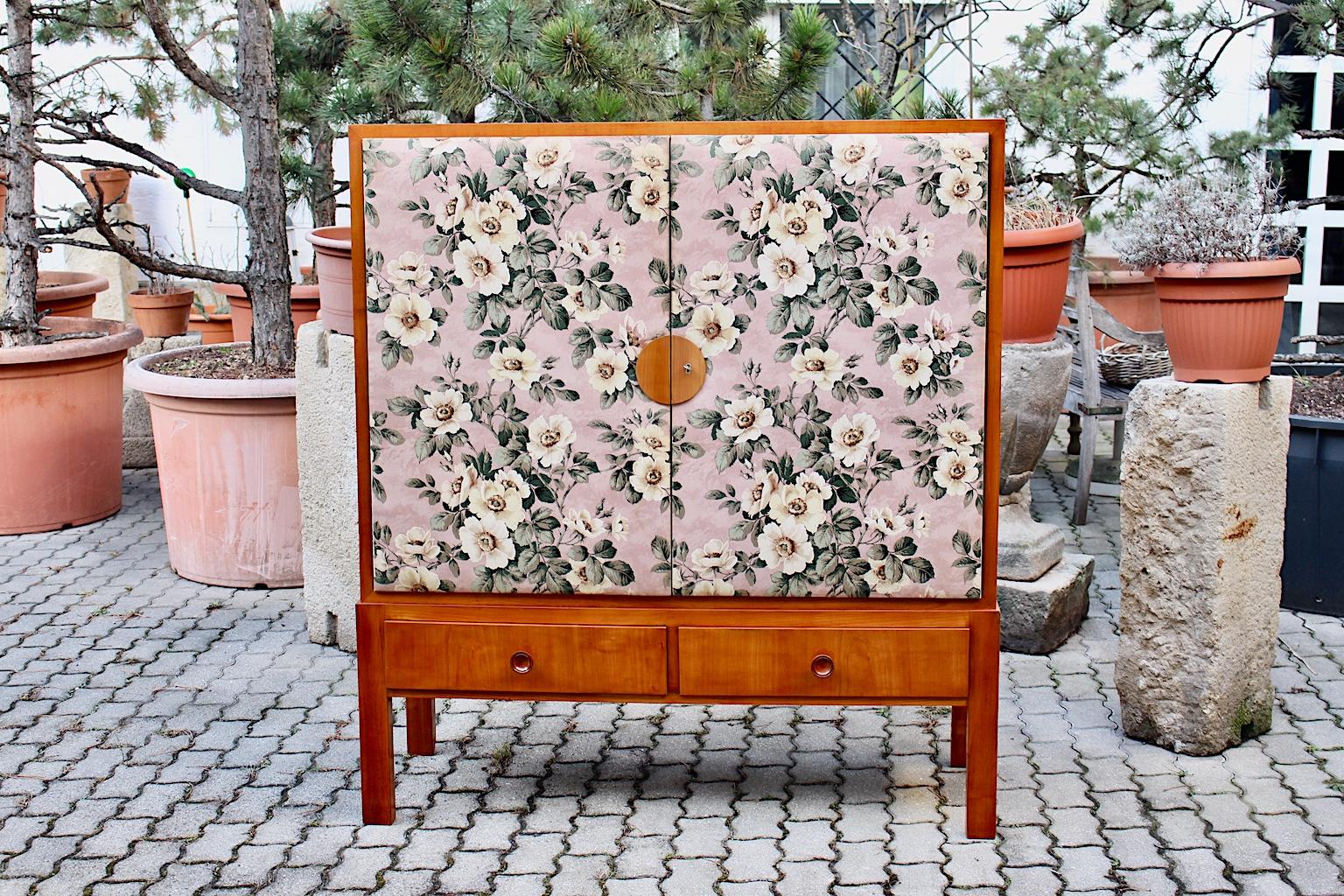 Art Deco vintage cabinet attributed to Josef Frank 1930s for Haus und Garten Vienna from cherrywood and flower pattern chintz fabric. 
The cabinet was made out of solid cherrywood in honey golden color tone, cherrywood veneer, beechwood veneer,