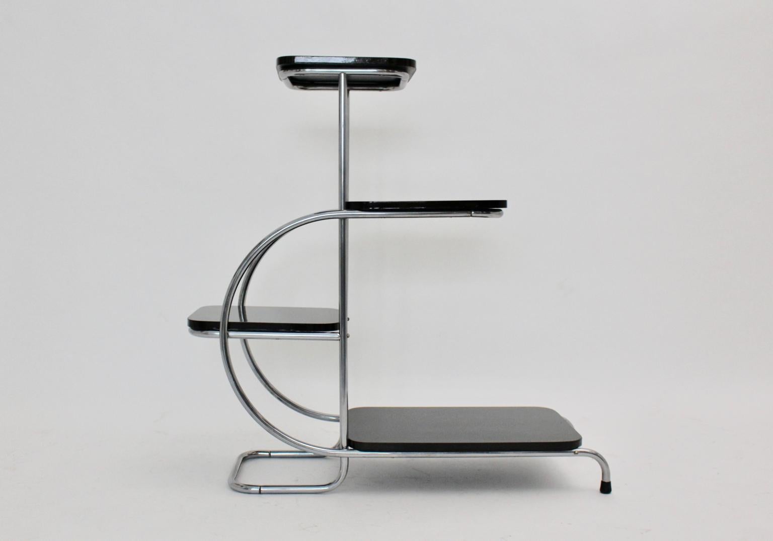 This curved side table or flower stand by Emile Guyot 1930s France, was made of chromed tube steel and black lacquered wooden plates. Also the side table shows two black rubber sabots.
This table is also well suited as a room divider.
Very good
