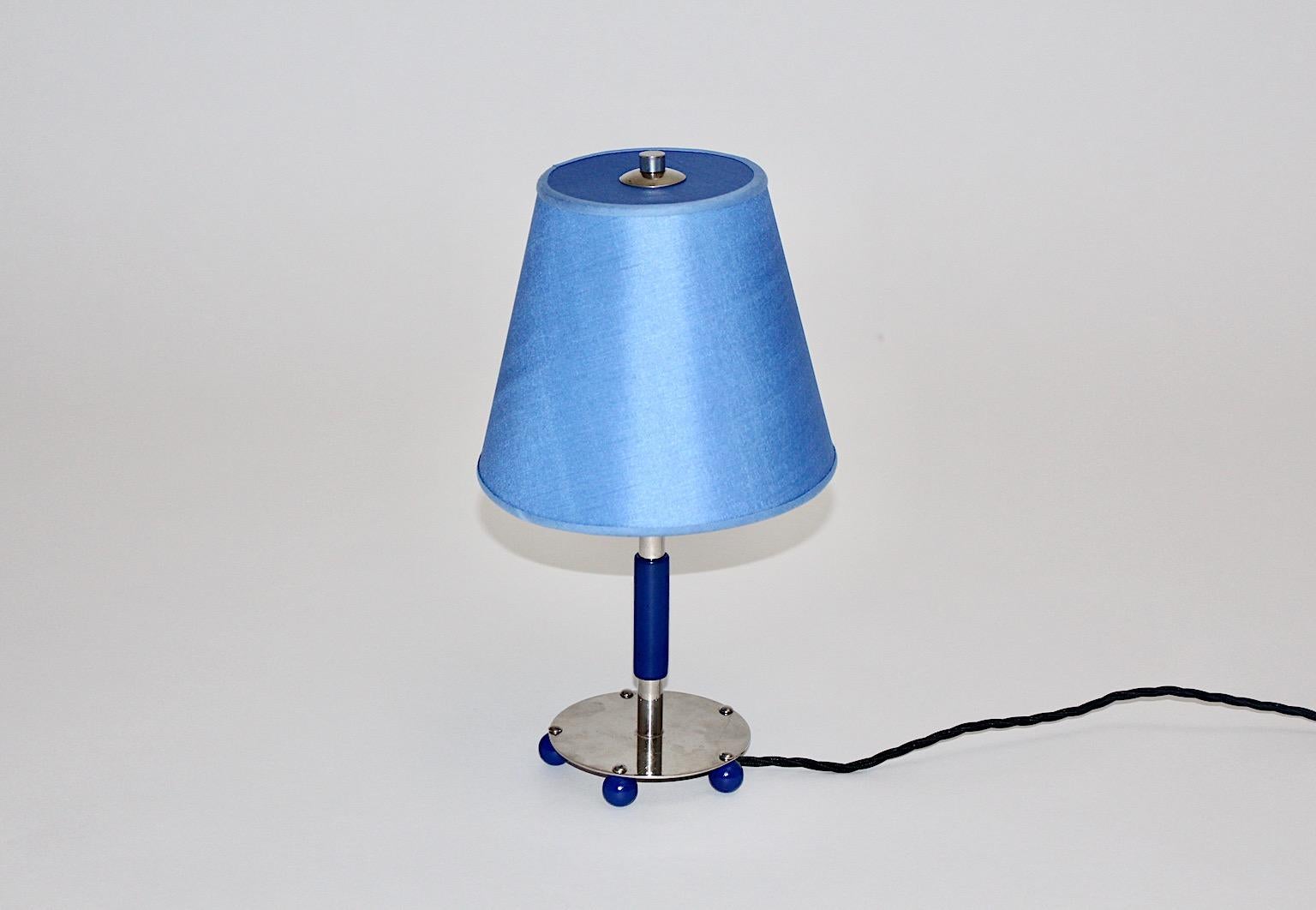 Art Deco vintage chromed tube metal table lamp with  blue wooden details., 1930s Germany.
A charming Art Deco table lamp with a new hand made lamp shade from fabric in funky blue color tone. Plus an adjustable shade function, you are able to move