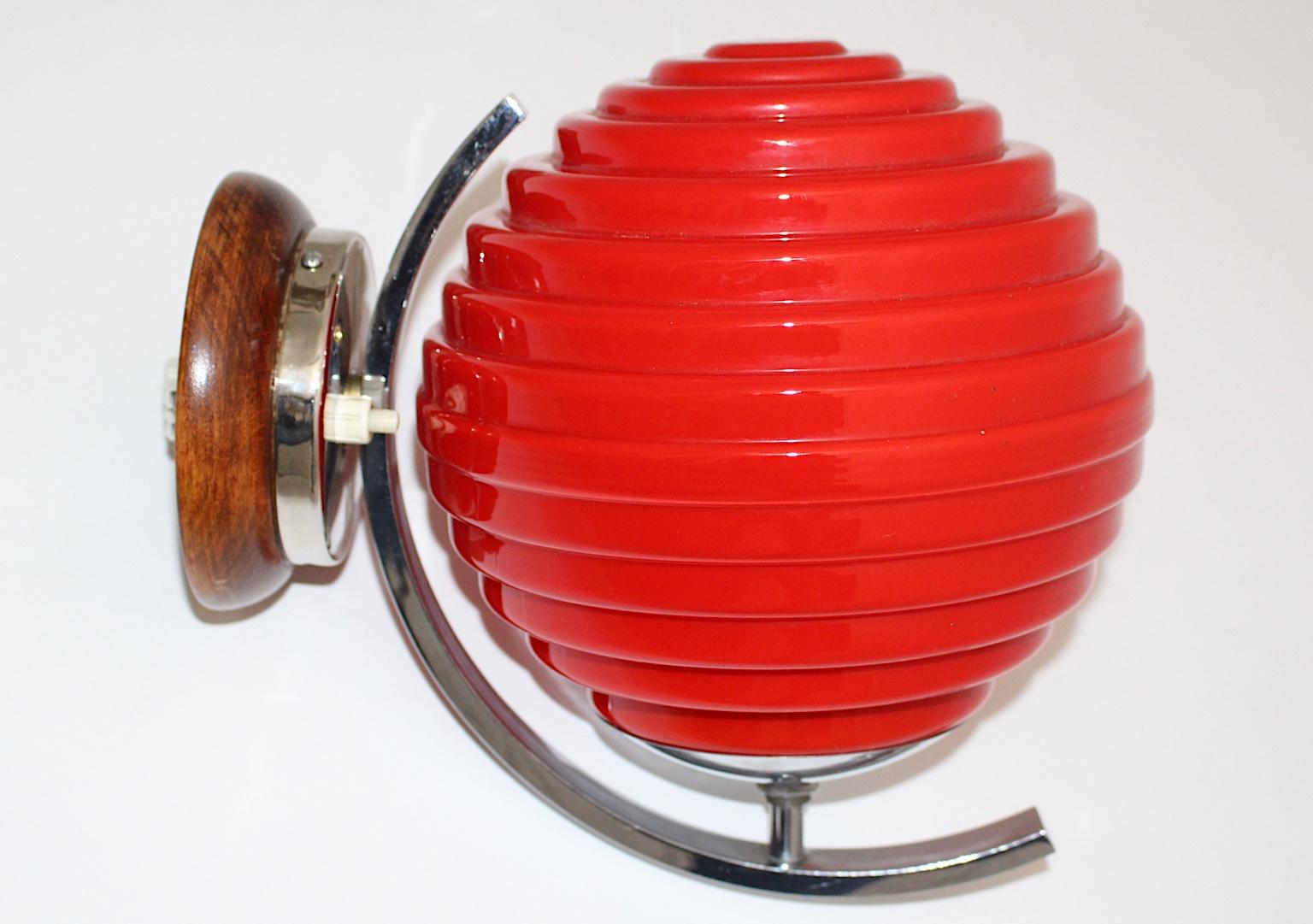 Art Deco vintage sconce or wall lighting from chromed metal and red glass shade Austria 1920s.
A gorgeous sconce or wall light Japanese lantern - like with a chromed metal fitting and a geometric shape bold red glass shade. The lamp shade shows