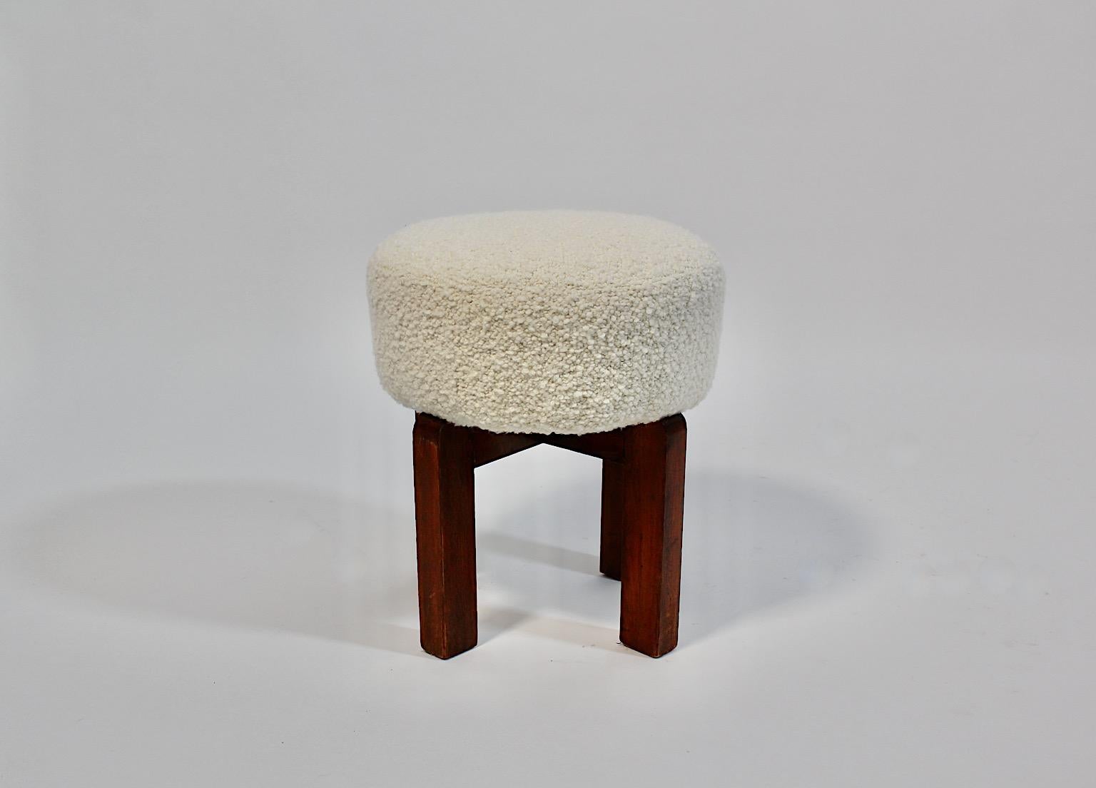 Art Deco Vintage circular stool or ottoman from stained beech and cream white fabric 1930s Vienna.
A stunning vintage stool circular like with for rectangular feet from stained beech in good original condition.
While the feet show good condition
