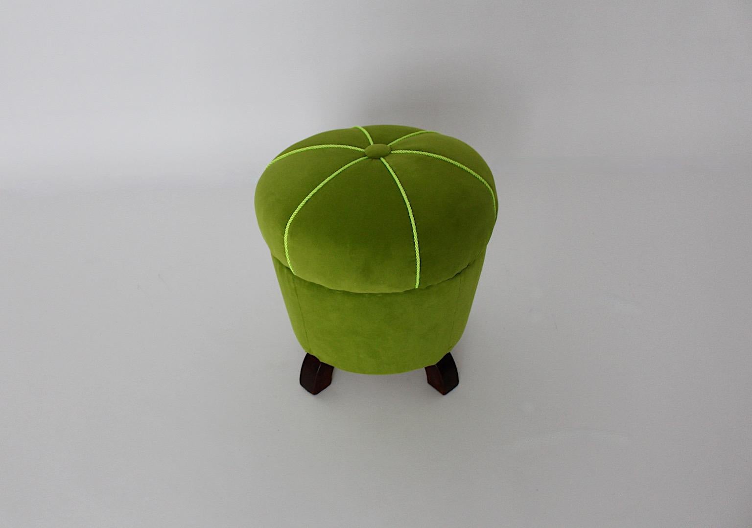 Art Deco Style vintage stool tabouret pouf from green velvet in circular shape and beech feet 1930s Austria.
An amazing new arrival, the velvet stool new upholstered and new covered with lime green velvet fabric and a nice decor button in the