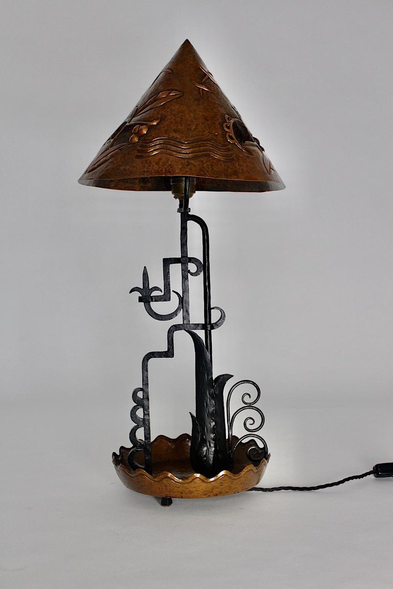  Art Deco vintage copper table lamp, which was designed and made out, circa 1920, Vienna.
The amazing table lamp was handmade of copper and black lacquered iron. The pointed hat shows the typical Art Deco ornaments, which were embossed.
The stem is