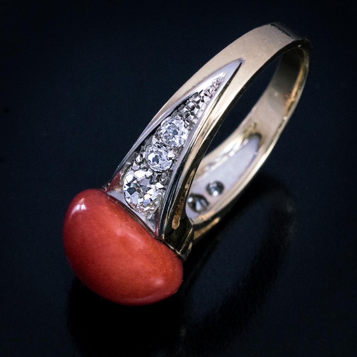 Circa 1925

This striking Art Deco era ring features a carved 12 mm wide natural coral of an excellent color. The coral is flanked by 6 chunky old mine cut diamonds. The ring is crafted in platinum and 18K gold.

Estimated total diamond weight is