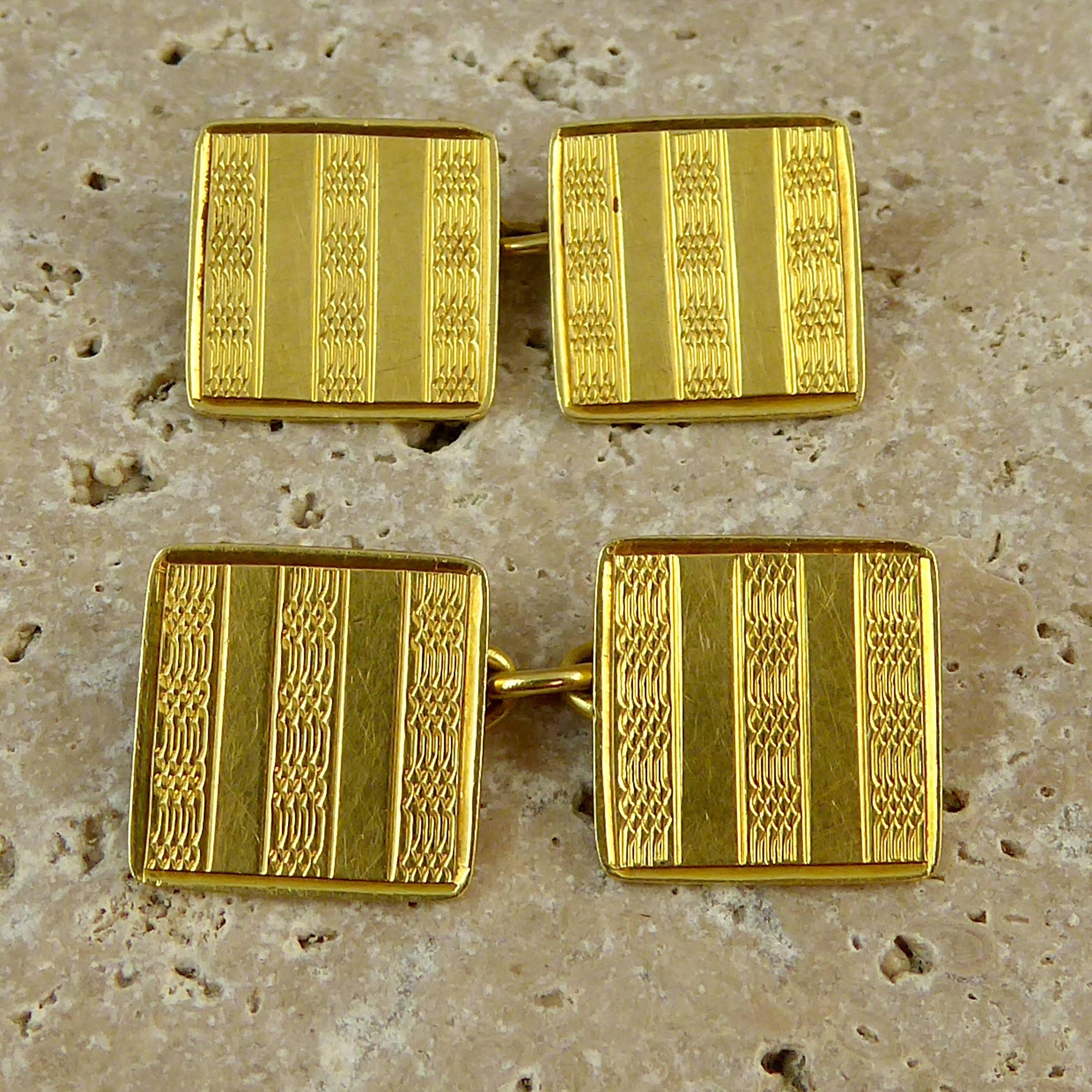 Art Deco cufflinks with engine turned engraved pattern.  The pattern has alternating stripes of a typical Art Deco wave pattern with a plain polished section.  Both sides of the cufflinks are decorated and they are connect by gold chain.