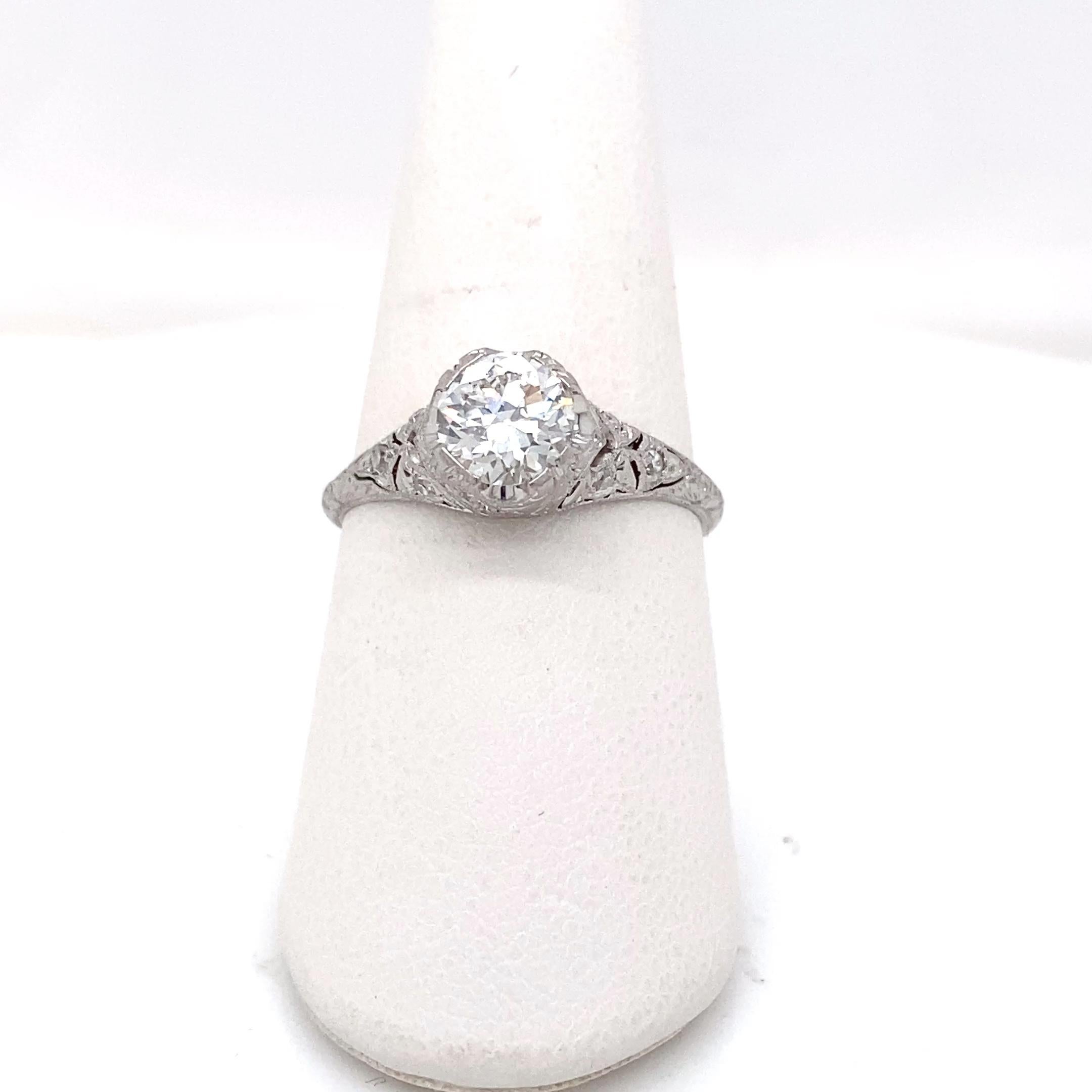 This stunning platinum ring showcases a 0.87 carat transitional-cut diamond graded H in color and VS1 in clarity, offering a brilliant balance of vintage charm and refined elegance.  Set in an authentic Art Deco, circa 1920s - 1930s, wheat motif