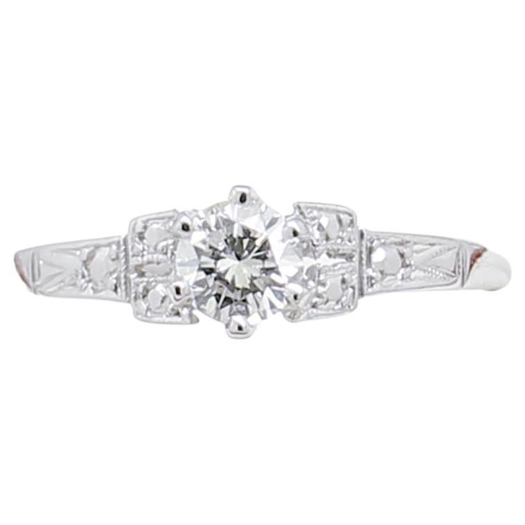 18ct White Gold engagement ring, narrow, low half round, tapered shank with under-rail, extended shoulders, 6 claw setting, polished finish, stamped (18CT).

The item contains:

One claw set natural round brilliant cut Diamond, clarity is 
