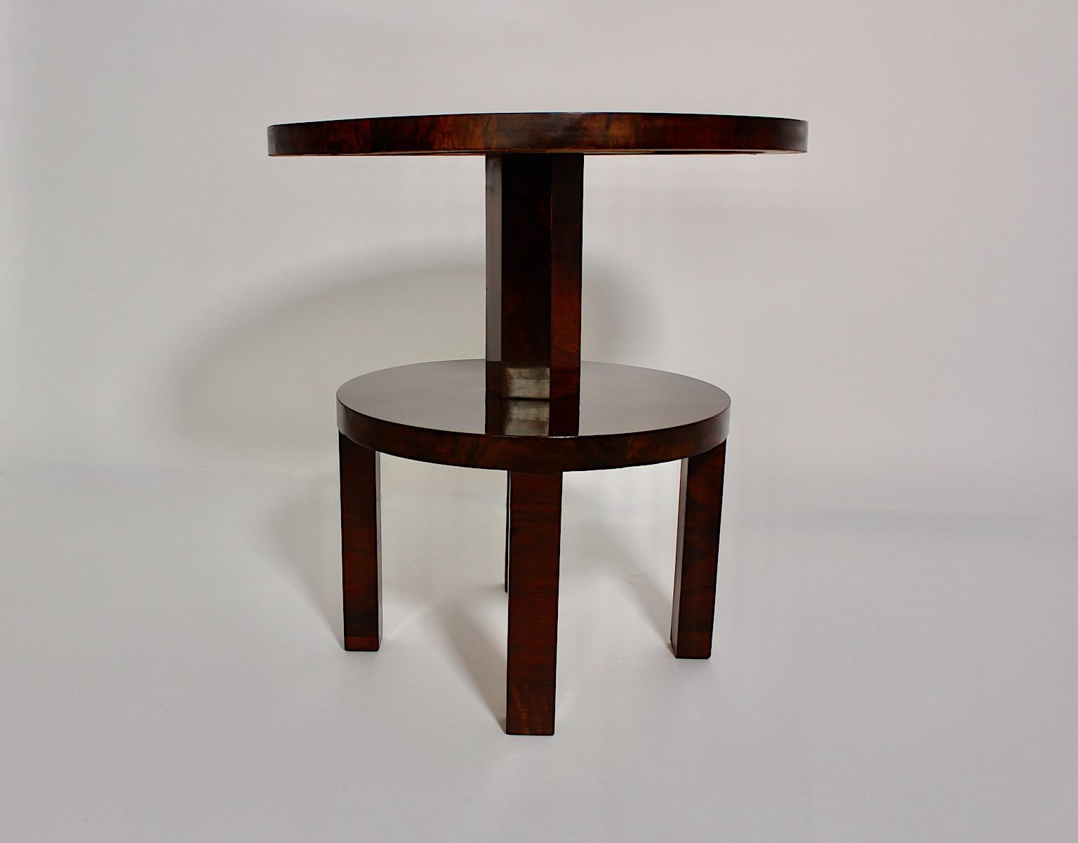 Art Deco vintage two tier circular coffee table or sofa table from walnut attributed to Ludwig Schmitt 1930s Vienna.
Ludwig Schmitt Kunsttischlerei was a high quality cabinetmaker, also K.& K. Hoftischlerei since 1898, located in the 1st district