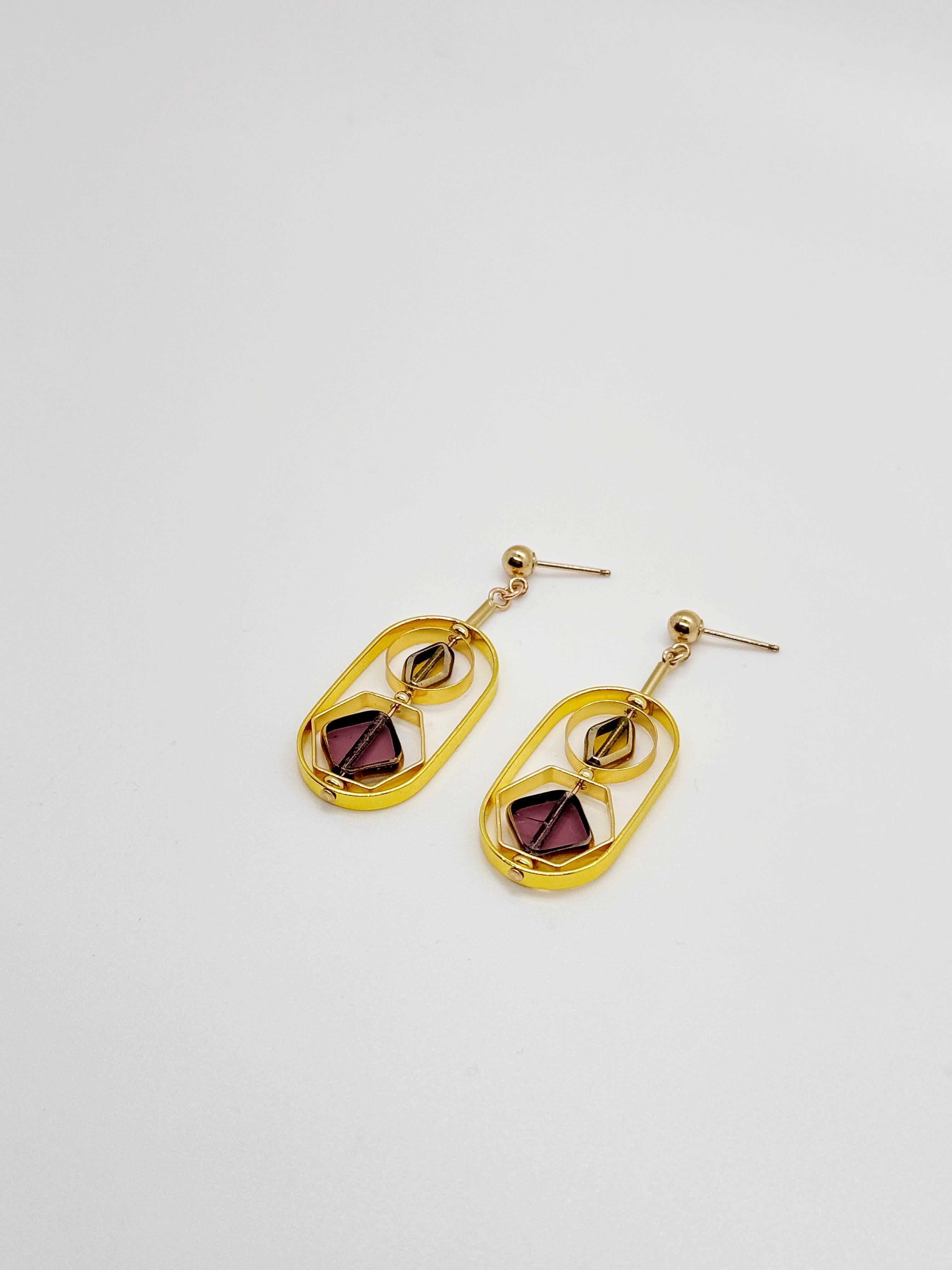 The earrings are lightweight and are made to rotate and reposition with movement. The earrings consist of small translucent yellow and translucent burgundy diamond shaped beads. They are new old stock vintage German glass beads that are framed with