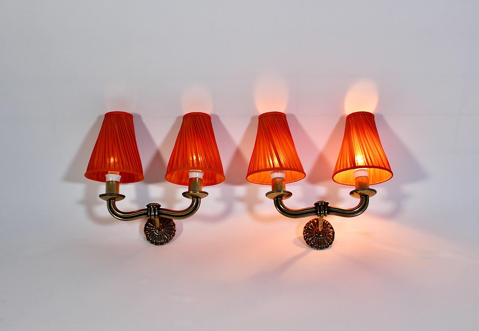 Art Deco Vintage pair or duo sconces or wall lights attributed to Hugo Gorge from brass in beautiful shape with orange pleated lamp shades from silk 1930s Vienna.
A wonderful pair of Art Deco sconces attributed to design by Hugo Gorge 1930s, each
