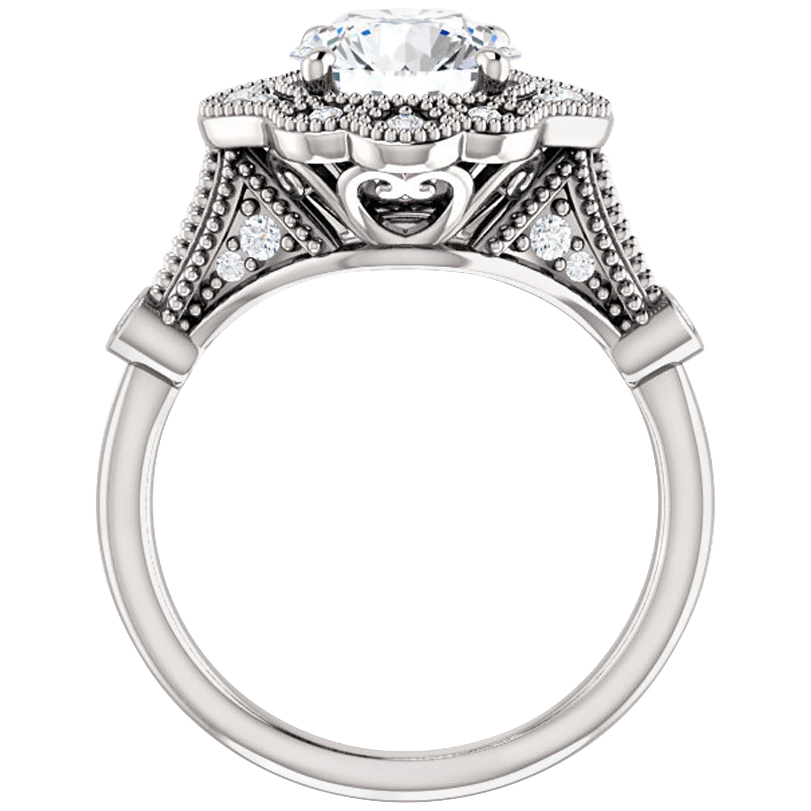 Glamorous shimmering diamonds surround the halo, amplifying the Forever One moissanite center stone. Additional diamonds dance aklong the shank of this vintage inspired engagement ring. Additional milgrain detailing adds heirloom appeal. Striking