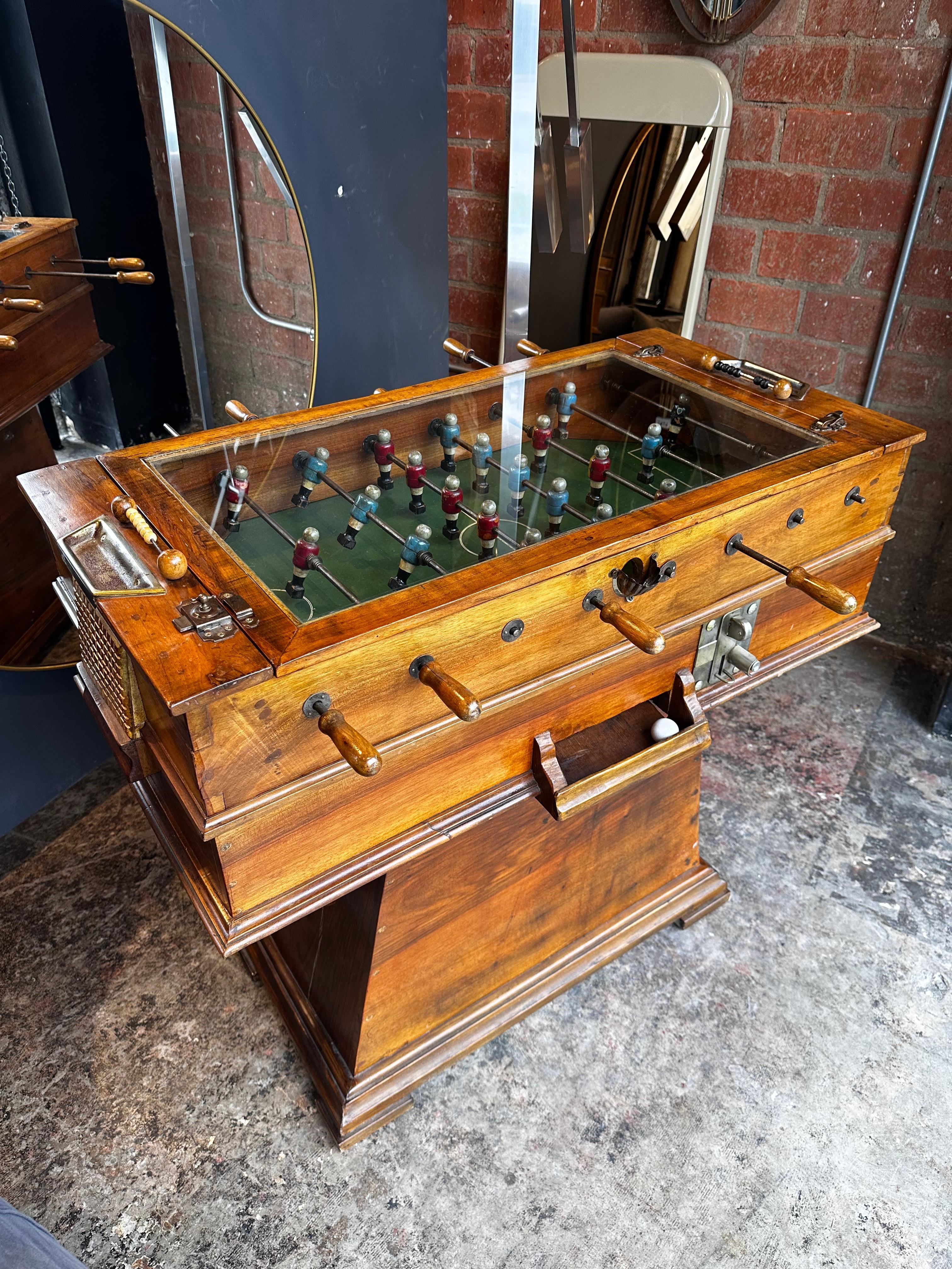 The Art Deco Vintage Italian Foosball Table from the 1940s is a rare and unique piece crafted entirely from wood and metal. This table features distinctive Art Deco design elements, showcasing the style of the 1940s. Its standout feature is a