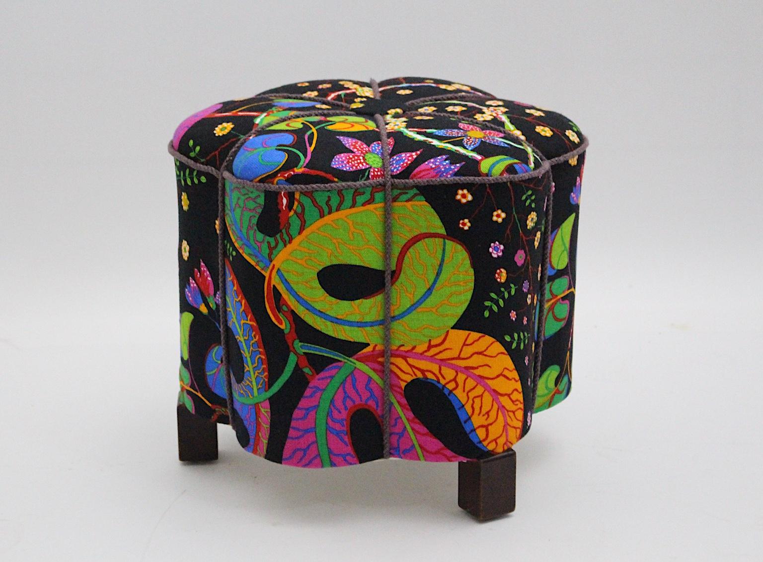 This amazing curved Art Deco vintage stool or pouf consists of a spruce base, beechwood feet and a renewed upholstery.
The beautiful and multicolored textile fabric covering was designed by Josef Frank in the 1930s and
is manufactured by Svenskt