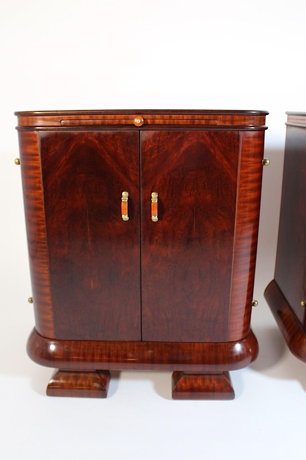 Art Deco vintage night stands pair duo from stained walnut, beech, ash and birds eye maple and bakelite and brass, 1930s Vienna.
A wonderful pair of night stands in various woods with beautiful fittings from bakelite in coral color tone and