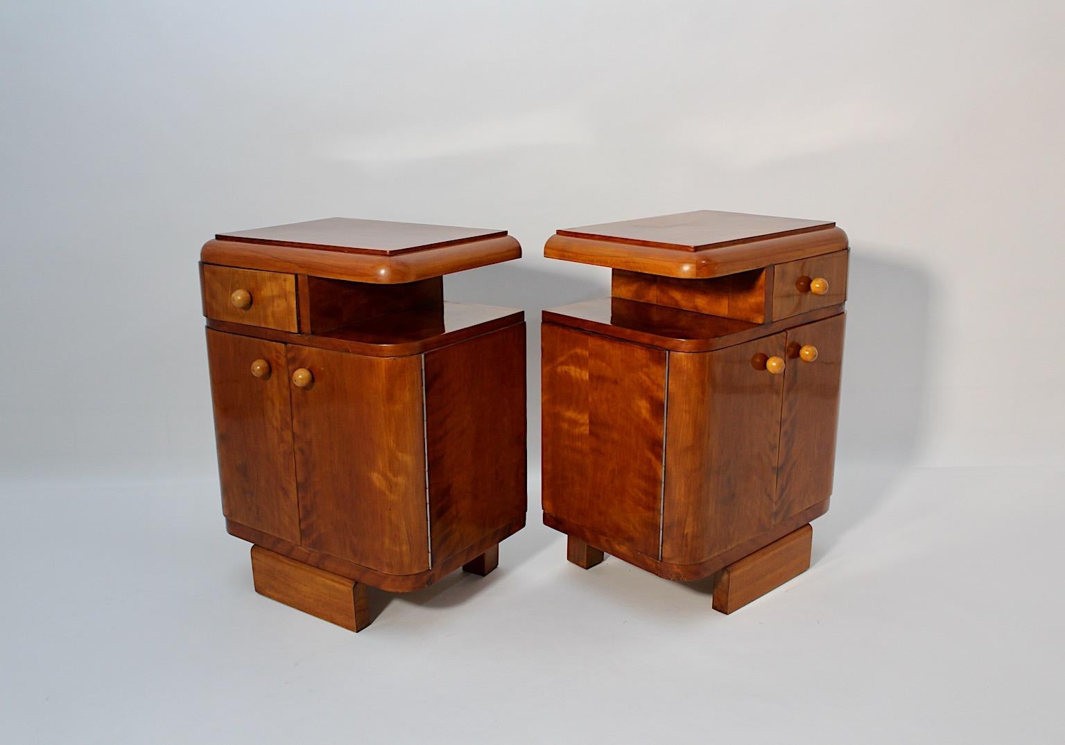 Art Deco vintage nightstands pair duo from plywood and maple veneer professionally shellac polished by hand, 1930s Austria.
A very beautiful Art Deco pair of nightstands or small chests, each with two 
( 2 ) doors and one ( 1 ) drawer and one ( 1 )