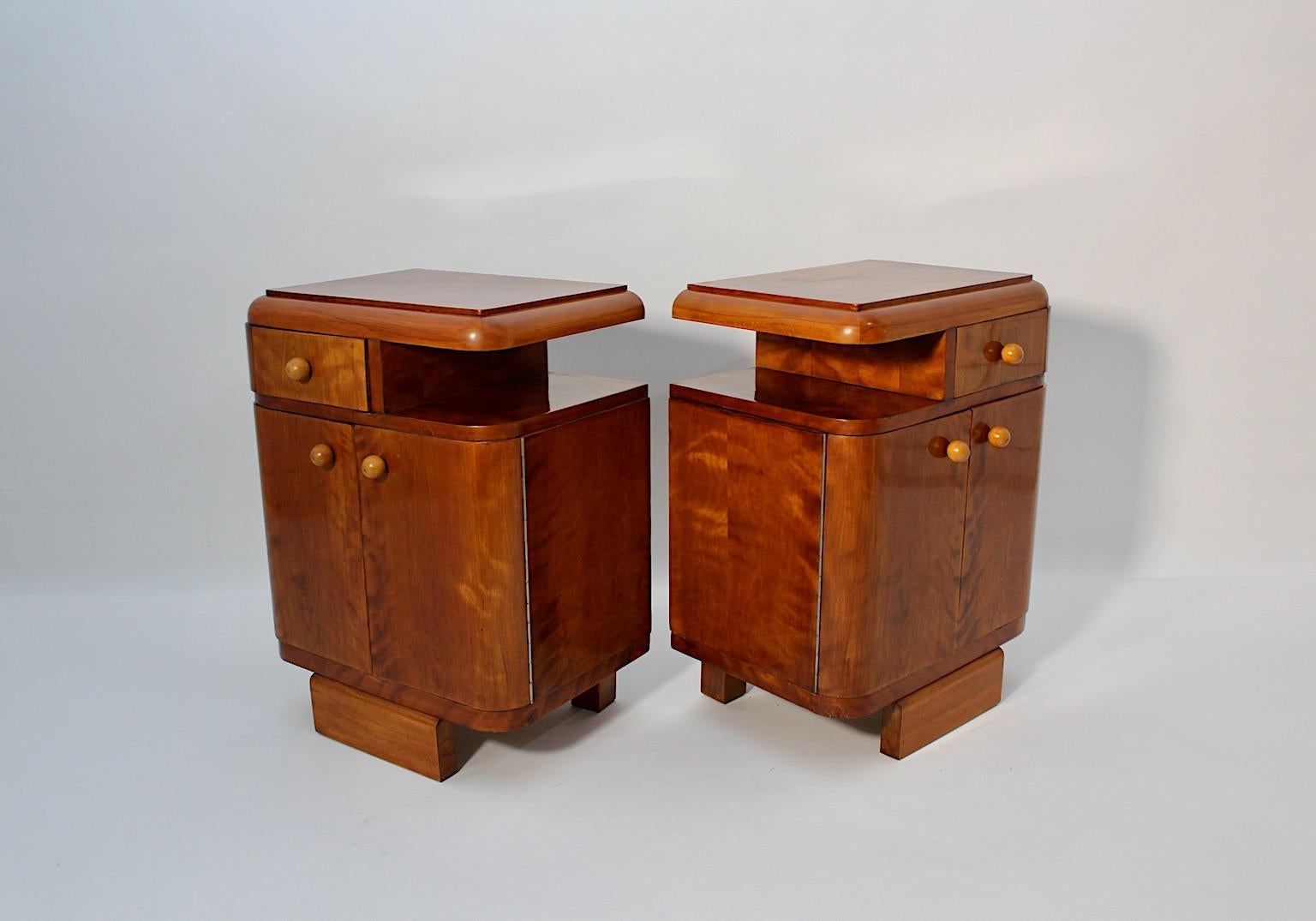 Art Deco vintage nightstands pair duo from plywood and maple veneer shellac polished by hand, 1930s Austria.
A very beautiful Art Deco pair of nightstands or small chests, each with two 
( 2 ) doors and one ( 1 ) drawer and one ( 1 ) storage