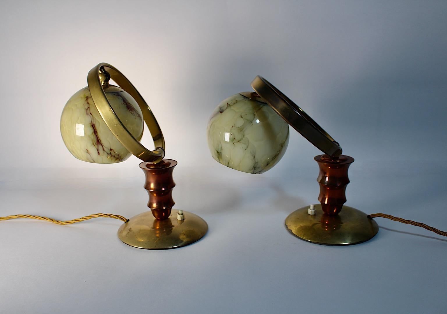 Art Deco vintage pair duo nightstand lamps or table lamps from brass copper and marbled glass in different brown color tones 1930s Austria.
A stunning and rare pair of table lamps or night stand lamps made from brass, copper and marbled glass in