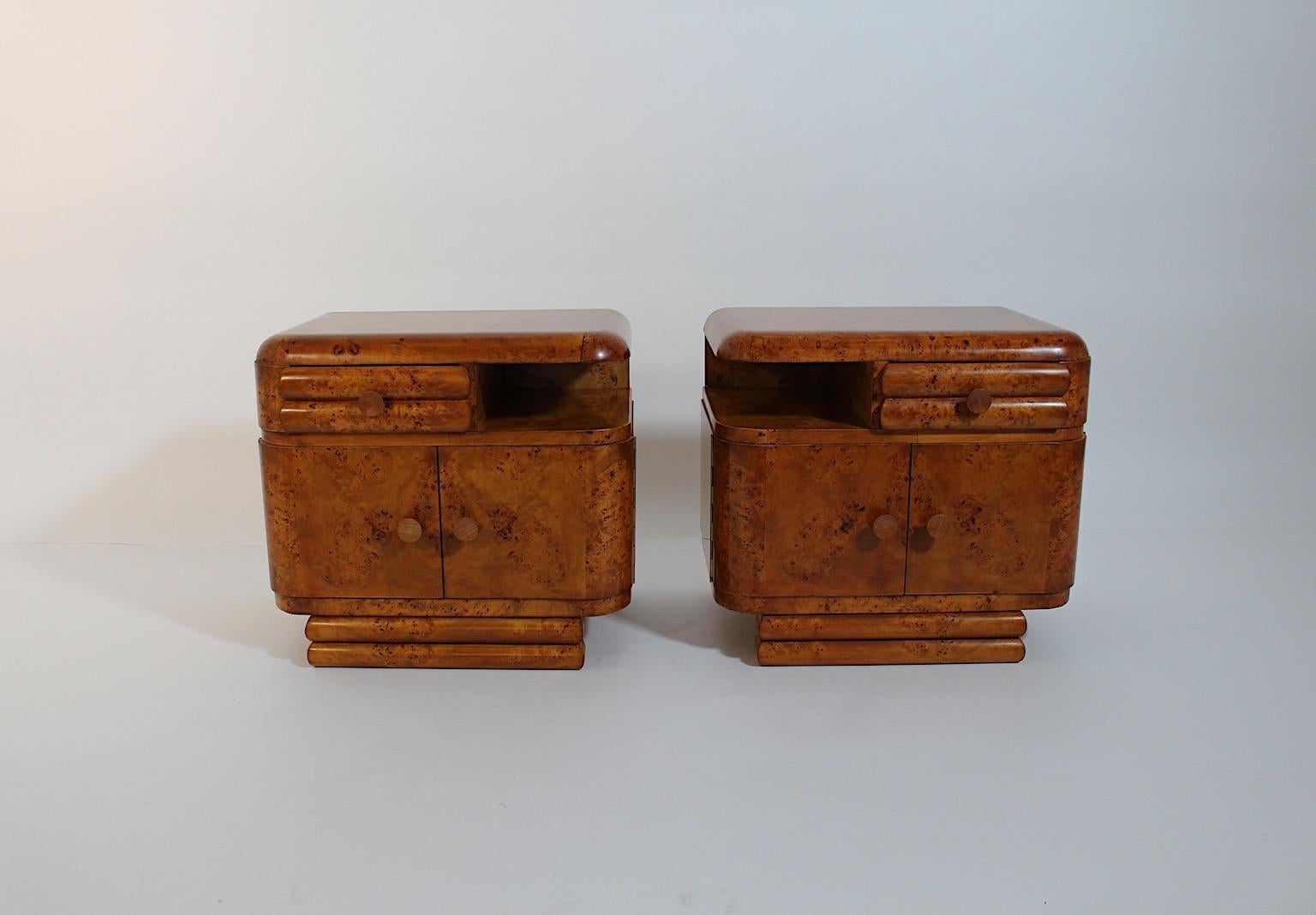 Art Deco vintage pair of nightstands or small chests from poplar 1930s Vienna.
A sophisticated pair of nightstands or small chests, each with 2 doors and 1 drawer, with a beautiful grain and a shellac polished surface by hand.
Through the shellac
