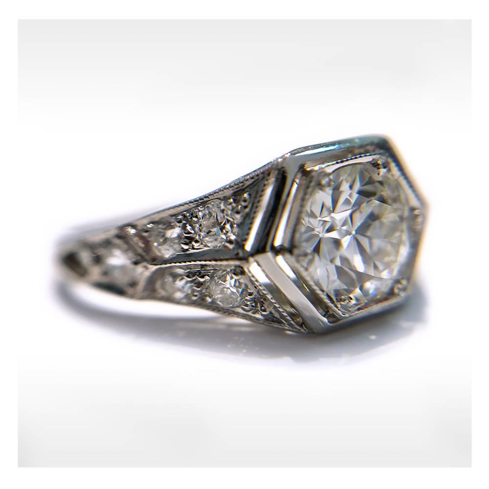 Art Deco Platinum Diamond Ring - Hexagon Setting, 0.92 carat weight. The round center Diamond measures 5.67mm for a carat weight of 0.65. The diamond is SI1 (G.I.A.) in clarity and G-H (G.I.A.) in color. The ring features milgrain detail around the