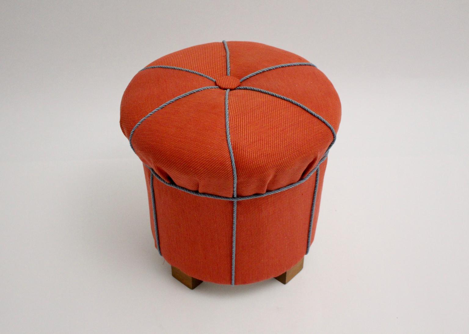 We present a delightful upholstered art deco pouf, Austria circa 1930, newly covered with red high-quality textile fabric by Svenskt Tenn and decorated with light blue cords and a button.
Also the pouf shows beechwood feet.
So the vintage